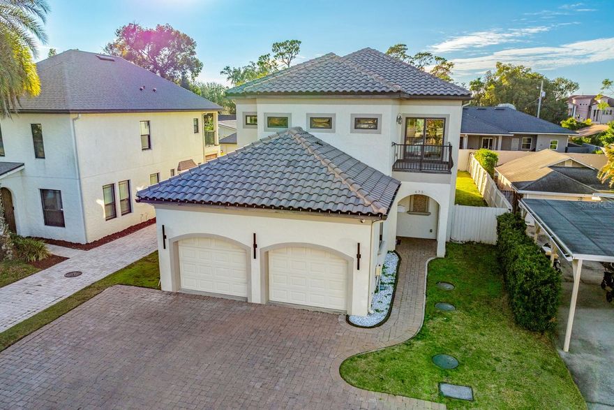 Seller may consider buyer concessions if made in an offer ~ Beautiful upgrades, a versatile layout, and the best of Winter Park at your doorstep! With Dubsdread Golf Course just around the corner and Fairbanks Avenue minutes away, this 4-bedroom, 3.5-bath CUSTOM BUILT HOME puts you in the center of it all – NO HOA required! Major systems have been well maintained; including a NEW A/C UNIT with UV lights (2025), FRESH INTERIOR PAINT, NEWER WATER HEATER (2021), double-pane windows, and the aerobic septic system was recently serviced (2022). All that is left is to move in and enjoy the lifestyle! This home’s flexible floor plan delivers TWO PRIMARY SUITES – one on the first floor and another upstairs – making it ideal for multi-generational living, in-laws, long-term guests, or simply room to grow. The downstairs suite features a spa-like en-suite bath with dual sinks, a SOAKING TUB, large glass shower, and a WALK-IN/THROUGH CLOSET that connects directly to the main floor laundry. Upstairs, the second suite offers a private bath and direct access to a balcony. The SECOND LAUNDRY ROOM upstairs and huge 30x11 BONUS/UTILITY ROOM provide even more convenience and space. At the heart of the home you will find a GOURMET KITCHEN, crafted with the home chef in mind offering an LG STUDIO REFRIGERATOR, INDUCTION COOKTOP, DOUBLE WALL OVEN, sleek stone counters and a complementary backsplash, upgraded cabinetry, and a large ISLAND with bar seating and chic pendant lighting. The kitchen flows seamlessly into the OPEN LIVING AND DINING AREAS, making everyday living or hosting family and friends a breeze. The LOFT at the top of the stairs delivers additional flexible living space and includes a wet bar with fridge, perfect for a casual hangout space, movie room, office space or anything else you or your family might need. TILE AND WOOD FLOORS, crown molding, and an abundance of natural light give the interior a modern yet timeless feel. Outside you will enjoy stylish curb appeal with a paver driveway – plus a COVERED LANAI overlooking a FENCED BACKYARD, and the spacious lot offers plenty of room for outdoor living. From golf, fine and casual dining to shopping, top-rated schools like Princeton Elementary, and easy access to I-4, 426, and 436, everything you love about Winter Park is right at your fingertips! This home offers the upgrades, the space, and the location you have been waiting for. Call today to schedule a tour and fall in love with your new HOME SWEET HOME!