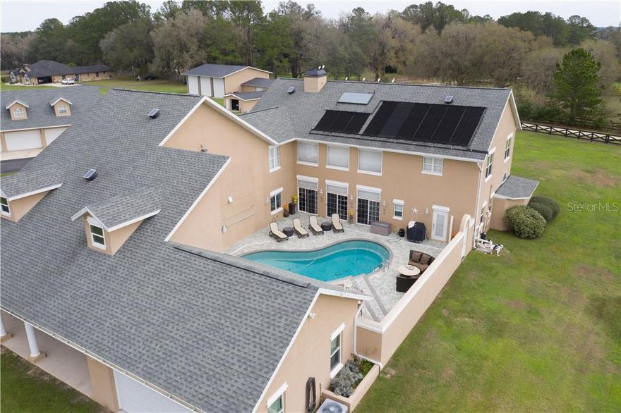 Location, Location!!! Minutes to HITS and just a short drive to WEC, this farm boasts 2  homes for the extended family, your trainer, or use it as a rental for added income.The 30 acre property features a main residence of +- 7000 sq. ft., with 5 bedrooms, 4 bathrooms, an in-ground pool, a 5 car garage. The truly stunning chef’s kitchen with a large gas range and a plethora of cabinets is a kitchen made to entertain the whole extended family & friends. Stone fireplaces, high ceilings, and natural wood accents throughout the home impart an upscale lodge feel. This home also features a personal elevator to the second floor of the home where you will find additional bedrooms and also a great entertainment room for the whole family. 
The second home with a generous 2,890 sqft of living space has its own entrance via the backside of the property. An additional building has room to house 5 cars and features a 2bed/2bath upstairs apartment of +- 1,200 SQFT of living space.  Ancient majestic oak trees provide shade and beauty to the pastures and lawns, one of Ocala’s symbols of our gorgeous thriving ecosystem. The  cross fencing is a picturesque amenity to the property, and being only 3 miles from HITS and a short drive to WEC, the property is in a great location to be a working horse farm. 1600 feet of road frontage has been cleverly equipped with a berm mitigating road noise. Don’t miss out on this lush 30 acre property. Call today for a showing.