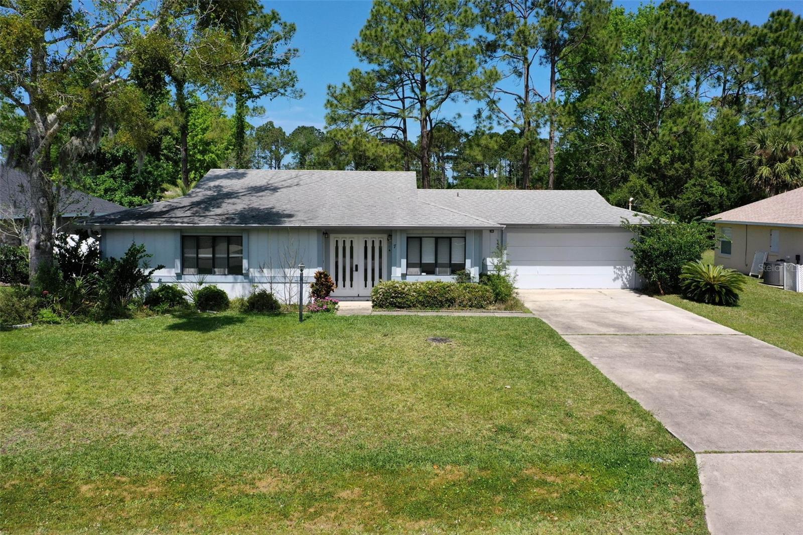 Charming 2-bedroom, 2-bath home in the desirable Pine Lakes community—perfect for buyers looking to personalize and make it their own. This light-filled home features an open living space, a functional kitchen with breakfast bar, ample cabinetry, and Stainless Steel appliances. The primary suite includes a private bath with dual sinks, while the second bedroom is great for guests, a home office, or hobby space. Relax year-round in the enclosed Florida room overlooking the backyard that has plenty of room to design our own private pool retreat! Additional features include a spacious 2-car garage and a prime location close to golf, shopping, dining, and parks. PRICE IS FIRM! Schedule your tour today!