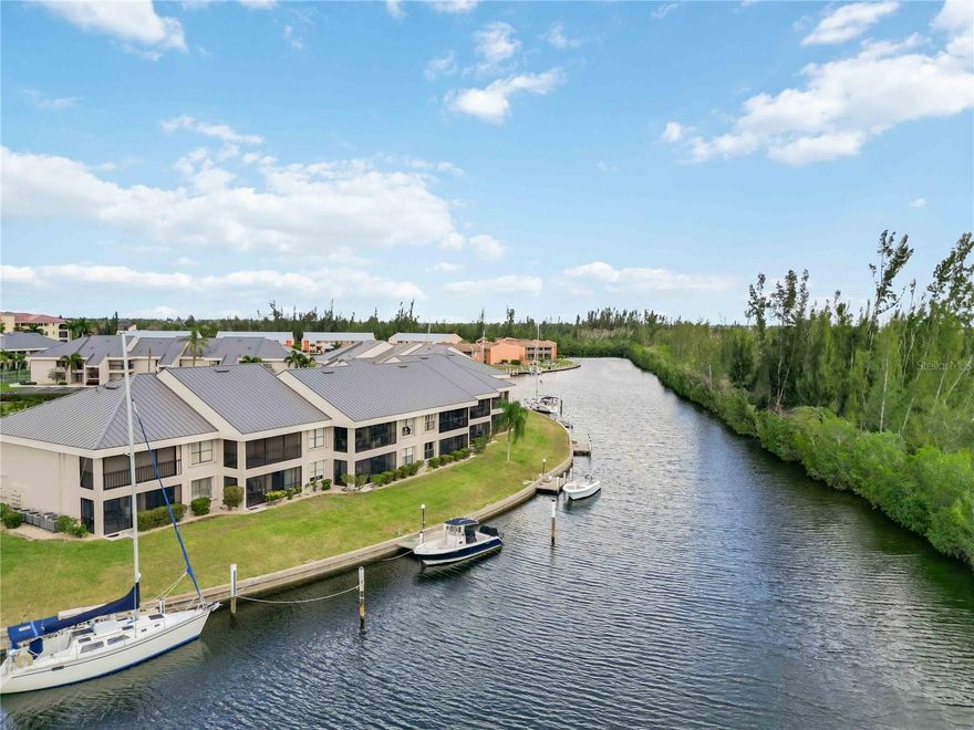 This 2-bed, 2-bath second-floor condo delivers SPECTACULAR SW-FACING SUNSET VIEWS over a deepwater saltwater canal from nearly every room. Boaters will love the PRIVATE CONCRETE DOCK with water and electric included in HOA, DIRECT SAILBOAT ACCESS to Charlotte Harbor and the Gulf - NO FIXED BRIDGES OUT and just 20 MINUTES TO OPEN WATER! Enjoy luxury vinyl plank and tile flooring throughout the main living areas, solid wood cabinets, stone countertops, and a bright open layout that flows seamlessly to your screened lanai overlooking the saltwater canal and conservation area where wildlife sightings and wide water views are your everyday backdrop. The primary suite features a walk-in closet and private bath. A NEW HVAC SYSTEM, accordion shutters, metal roof, inside laundry, and LOW HOA fees covering water, sewer, pest control, pool, and more make this truly effortless coastal living. Pet friendly, investor friendly with 1-month minimum lease. Community amenities include pool, tennis, pickleball, clubhouse, and community boat ramp. Minutes to downtown Punta Gorda, Fisherman's Village, Sunseeker Resort, and I-75. Don't miss this rare opportunity to own your piece of Florida waterfront paradise!