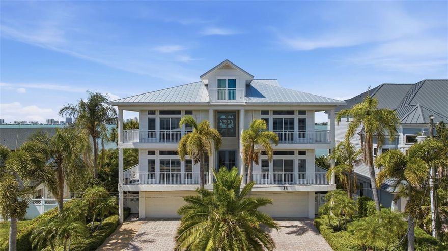 One or more photo(s) has been virtually staged. Exceptional waterfront estate in Belleair’s coveted North Pine Circle, offering unobstructed open-water views of Clearwater and beyond. The soaring 21 feet high entry foyer and wraparound balconies introduce the home’s grand scale and elegant architectural design with breathtaking bay and intercoastal waterway sunsets. Designed for both everyday living and delightful entertainment, the interior features rich woodwork, custom details, and streaming natural light throughout. Highlights include waterfront living and dining areas. The family room boasts a custom coffered ceiling, gas fireplace, wet bar, wine refrigerator and custom built-in entertainment center. The gourmet kitchen is complete with Sub-Zero and Wolf appliances, Brazilian granite countertops, dual sinks, Bosch digital dishwasher, and center island with plenty of storage, a granite breakfast bar, solid Buttercream wood cabinets, and reach in pantries with stainless steel revolving shelves. The expansive pantry/laundry room provides its own sink and LG ThinQ Front Load Washer/Dryer. Additional luxury features include a fully appointed executive’s office with hand carved cherry wood built desk, filing and storage cabinets, oak wood herringbone floors and ensuite guest bathroom. The giant game room showcases a climate-controlled hand-crafted cherry wood wine storage. Four ensuite bedrooms with private balconies, including a stunning waterfront primary suite with fireplace, built-in entertainment center, spa-style bath with granite finishes, jetted tub, dual vanities, and two giant walk-in closets. A private elevator serves all 3 floors accessible from the 4 car garage. The upper level includes a spacious multipurpose bedroom, full whirlpool bath and separate shower, generous closet space, and a private balcony with panoramic water views. Enjoy the waterfront resort-style pool and spa, lush tropical landscaping, and a private dock equipped with a pontoon lift and 54,000-pound boat lift. - Centrally located minutes from Belleair Beach, Belleair Country Club, Pelican Golf Club, Clearwater Beach, and the Morton Plant Hospital/BayCare Medical Centers