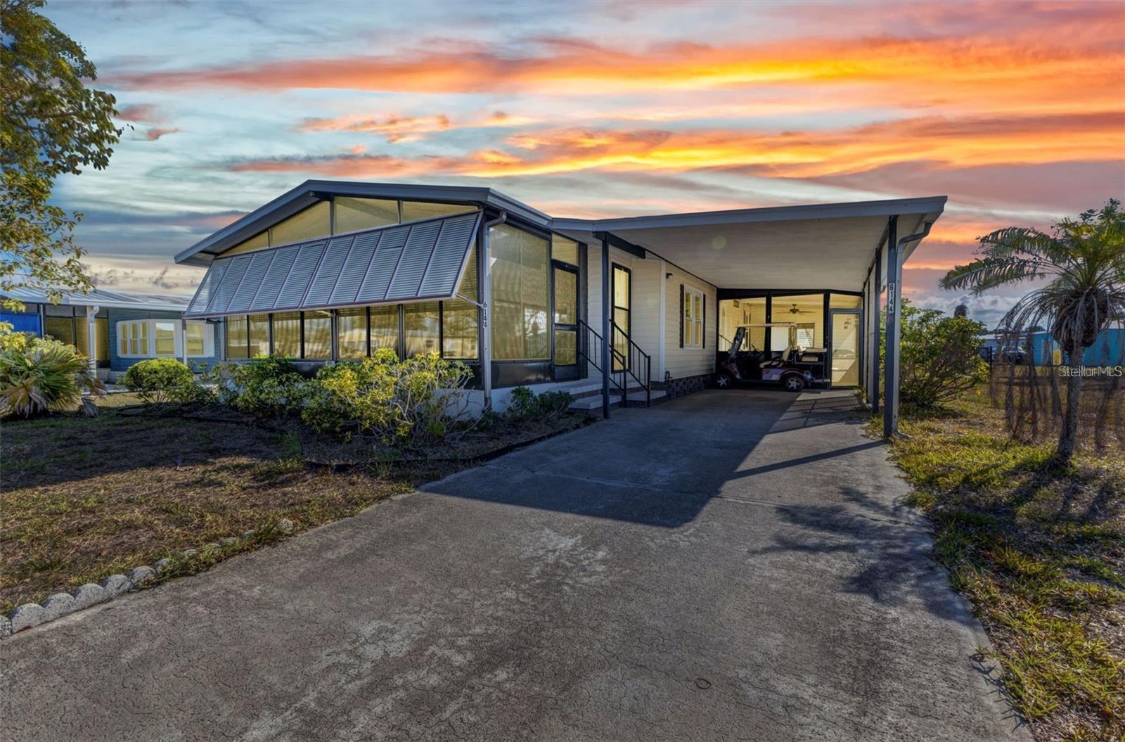 Welcome to this beautifully maintained 2-bedroom, 2-bath manufactured home, nestled in an active 55+ community just minutes from Manasota Key and Englewood Beach! Step inside to discover an open, airy layout with generous living and dining spaces, complemented by a well-appointed kitchen featuring warm wood cabinetry. French doors invite you into a BRAND NEW 2025 spacious 22' x 12' enclosed front lanai—perfect for morning coffee or relaxing evenings. Enjoy even more outdoor living with a second screened lanai, plus a separate workshop complete with utility sink for hobbies or storage. The expansive primary suite offers a peaceful retreat, boasting a walk-in closet, garden tub, and separate shower. Additional highlights include an air-conditioned laundry room, insulated windows, and a NEW fully fenced backyard—ideal for pets or gardening. Best of all, ITS FEE-SIMPLE—you own the land! This pet-friendly, golf cart-friendly community offers fantastic amenities for just $300/year, including a clubhouse, pool, tennis courts, and more. Don’t miss your chance to enjoy affordable Florida living at its finest!