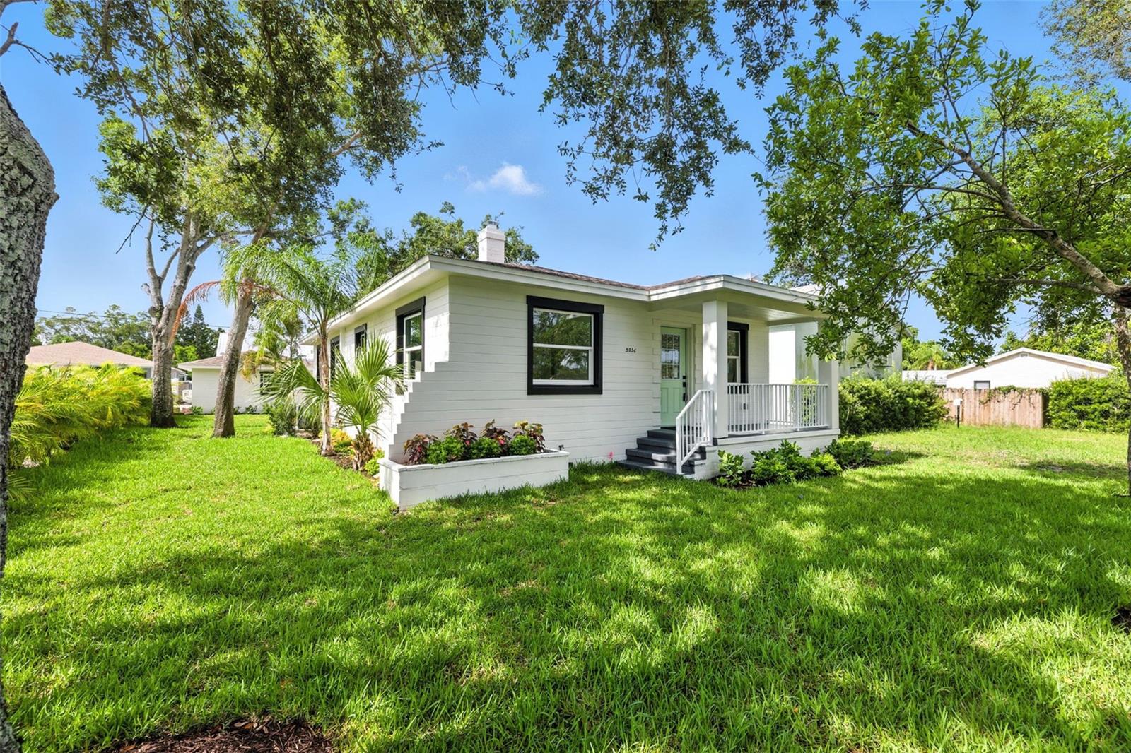 Welcome to 5036 22nd Ave N in the heart of St. Petersburg! This fully renovated block construction home features a complete 3-bedroom, 2-bathroom main residence plus a private detached efficiency unit in the rear—complete with its own full kitchen, walk-in shower, full bath, walk-in closet, and ample space for a king-size bed with a seating area. Perfect for multi-generational living, guest accommodations, or long-term rental income. The main home is filled with natural light and showcases a jaw-dropping kitchen with modern finishes, dining space, and inside laundry. No detail was overlooked—new roof, new windows, new A/C, new hot water heater, new flooring, updated plumbing and electrical, fresh landscaping, and a full irrigation system. Additional features include alley access, a non-flood zone location, and a neighborhood surrounded by new construction homes—all adding to the long-term value and appeal. This is a rare opportunity to own a move-in-ready, income-producing property in one of St. Pete’s most convenient and growing areas—close to shopping, dining, downtown, and the beaches. This home truly has it all.