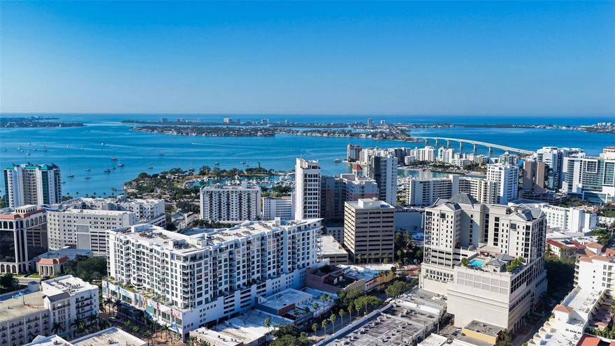 Welcome to The Mark- where it’s all happening in downtown Sarasota. This incredible city-view unit is the perfect height and position in the building- facing east for sun-filled mornings, it looks directly down State Street and at the city below. The Mark is a wonderfully amenitized newer building in the core of downtown Sarasota.  Just out your front door is access to the finest in dining, shopping, and entertainment that Sarasota has to offer. Inside the building you will find a true oasis- you’ll be greeted by the friendly concierge, take the elevator up to you level and enjoy privacy and elegance. The amenities in the building include a heated pool and spa deck area with peek-a-boo views of the water and cityscape, outdoor seating and cabanas, a luxurious fitness center, meeting room, shared office area, grilling area, catering kitchen and much more. This unit stands out with one extra wide end parking space that was hand selected by the seller, and there is a 6x4 storage unit right across the hall. Inside this residence are lovely upgrades including tile in the main living area, automated blinds with blackout shades in the bedrooms, recessed can lighting, separate laundry room with sink, grass cloth accent walls and much more. You’ll love the open floor plan with bedrooms on either side, each with its own en-suite bathroom. There is a powder room for entertaining and abundant space for sitting and hosting in the main area. There is a tucked-away office area with built-ins, custom lighting throughout, and no storm concerns with impact glass windows in all openings! The luxurious kitchen features an island with bar seating, stainless steel appliances, custom glass tile backsplash and more. The primary suite offers abundant space, dual closets, bathroom with separately enclosed walk-in shower and commode, dual vanities, and access the balcony. The lovely east facing balcony is a great retreat to sit and let the day greet you, and even see the warm glow of sunset skies over the city in the evening. This unit has been lovingly cared for its original owner- don’t wait- schedule your private tour today!