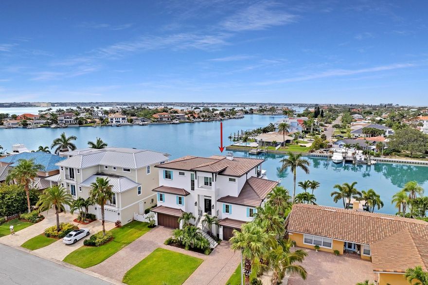 The ultimate in luxurious coastal living! Magnificent waterfront estate home with uncompromising attention to detail. Sweeping, panoramic water views and a short walk to beautiful Belleair Beach. The double door entry brings you to the grand foyer with 22 ft high ceilings, a wide-open floor plan and a breathtaking water view! The desirable great room layout manages to be elegant yet warm and inviting with a beautiful custom mantle and fireplace. Family and entertaining space is extended with a 33 ft wide covered waterfront balcony accented by gorgeous wood ceilings and fine shell stone flooring… stunning! And of course, the balcony and great room are open to the heartbeat of the home, the fabulous epicurean kitchen! Massive center working island/breakfast bar, Wolf/Bosch/Subzero appliances, white shaker style cabinetry with crown molding, a large walk-in pantry and even a separate butler’s pantry and service area. The primary bedroom suite offers its own sitting area/office, a spa retreat style ensuite with custom tilework, soaking tub, walk-in shower, marble vanities with custom fixtures and a private balcony perfect for morning coffee or an afternoon cocktail. The upper-level features three large bedrooms, two beautifully appointed full baths, a student study area with endless possibilities and a large media room that opens to an enormous, covered waterfront balcony with spectacular water views. The outdoor wonderland includes an impressive shell stone pavered pool deck and 50 ft covered entertainment area with a gas cooking center. The Pebbletec finished pool and hot tub boasts a sun shelf and features a saltwater system. Composite dock and boatlift have seating and a convenient step down for docking. An outdoor paradise to be sure! Additional features include a whole-house generator, indulgent 3-stop elevator, temperature-controlled wine center, enormous laundry room with workstation or craft area. And too many luxurious finishes to mention! Exquisite craftsmanship, extravagant lighting, rich woodwork, extensive wainscoting, striking hardwood flooring, soaring 12 ft ceilings, plush window and wall treatments. No detail overlooked. This home shows the perfect balance of elegance and waterfront lifestyle. True luxurious coastal living!