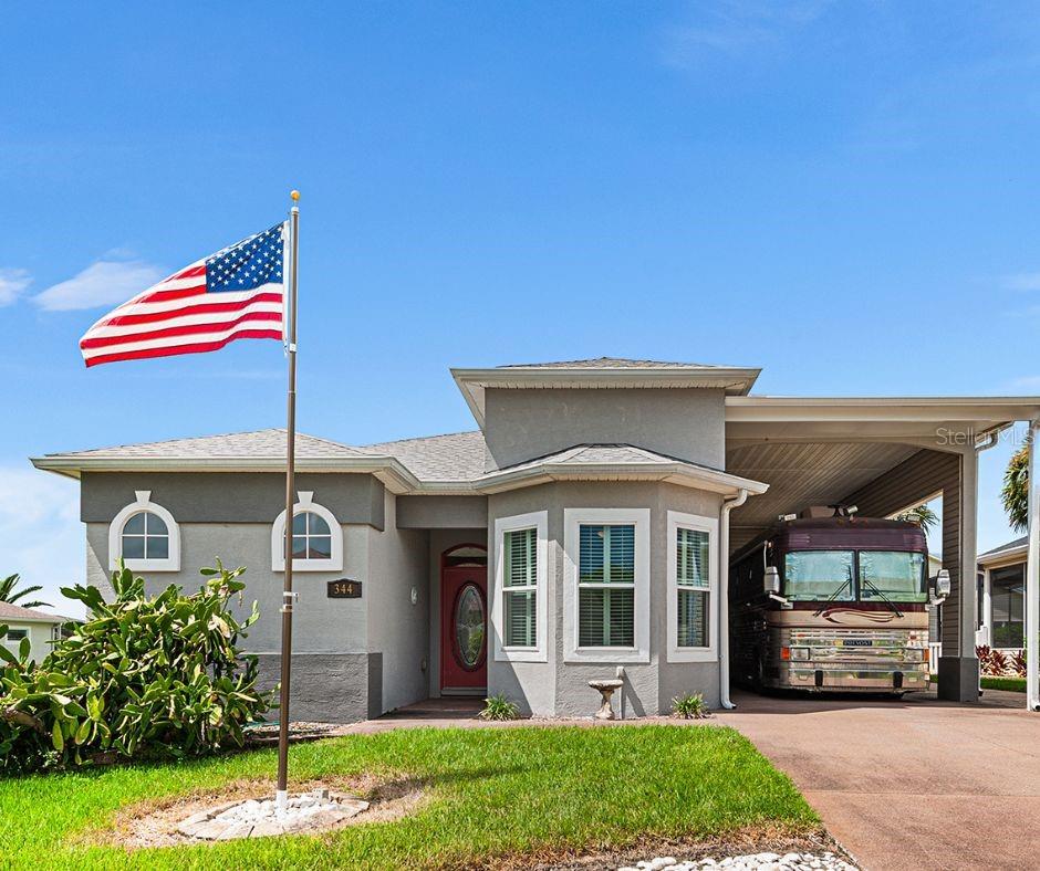 Move right into this beautiful 2 bedroom, 2 bath home with a den, offered fully furnished in a highly desired 55+ RV community. Designed for both comfort and convenience, this home features soaring 10-foot ceilings with 8-foot doors that add a spacious, elegant feel. The open floor plan is finished with tile throughout the main living space, plantation shutters, and double-pane windows that fill the home with natural light. The kitchen is a true highlight with granite countertops, stainless steel appliances, and plenty of storage. The den with built-ins and pocket doors makes the perfect office, hobby room, or flex space. Retreat to the primary suite, showcasing trey ceilings, a walk-in closet, and a huge shower with dual shower heads for a spa-like experience. Practical upgrades include a 2024 roof, new insulation, and a well for irrigation. An attached workshop under AC gives you the ideal space for projects year-round. Step outside to your huge screened lanai, perfect for morning coffee or entertaining friends in true Florida style. This property blends modern updates, thoughtful design, and the lifestyle you’ve been waiting for—all in a welcoming RV community setting. Don’t miss this one!