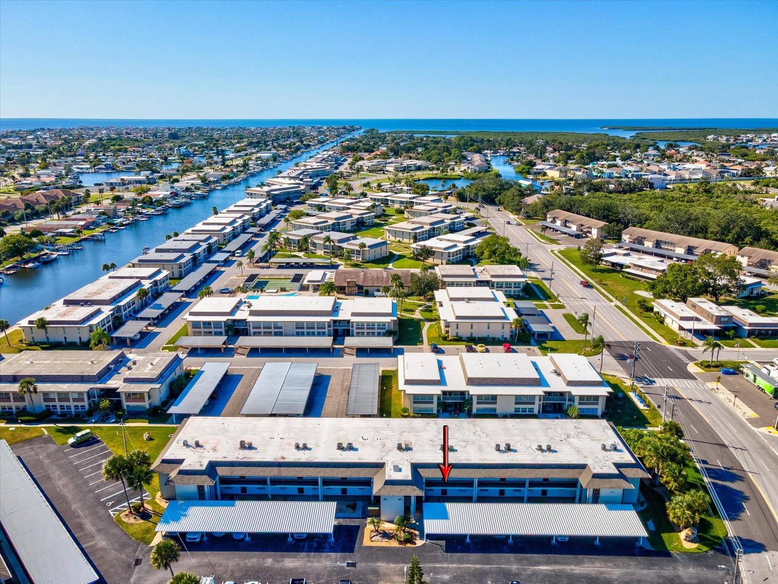 Welcome to Waterfront Living at Windward Cove! Step into this beautifully renovated 2-bedroom, 2-bathroom first-floor condo nestled in one of New Port Richey’s most desirable waterfront communities. Enjoy a light and bright open floor plan with updated flooring, a spacious living area, and sliding glass doors leading to an enclosed patio. The kitchen features ample cabinetry and a breakfast bar that opens to the dining area, ideal for entertaining. The primary suite offers lanai access, a large walk-in closet, and a private ensuite bath. A split-bedroom layout provides comfort and privacy for guests. Windward Cove is a Gulf-access community with a heated pool, waterfront deck, community dock, and boat slips (available for rent). Condo fees include water, trash, cable, internet, and exterior maintenance — making this a true low-maintenance lifestyle. Located minutes from downtown New Port Richey, shopping, restaurants, parks, and beaches, this home perfectly blends tranquility and convenience.