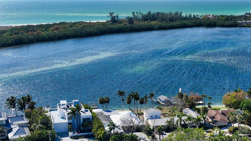 When visionary circus magnate John Ringling purchased the land now known as St. Armands circle, he envisioned creating a world-class attraction comprised of luxury waterfront real estate and an abundance of shopping and dining options around the circular hub. Today, waterfront property owners on St Armands circle (of which there are only 81) have the luxury of living just steps from the famed shopping district with more than twenty eateries, affording them a blissful atmosphere of relaxed elegance in a park-like setting with palm-lined medians and tropical plantings.  For the first time in nearly 40 years, this waterfront property is being brought to market for a new owner to write the next chapter. With over 12,000 SF of land, featuring a majestic Royal Poinciana tree, 83’ of water frontage, a newer seawall, a dock, and boat lift, this parcel offers the perfect canvas for an architect and builder to design and construct a modern masterpiece. Overlooking Pansy Bayou, a protected Manatee refuge, the property affords unparalleled privacy, unobstructed Bay views, and the opportunity to marvel at the presence of Sarasota’s gentle “sea cows.” Public boating entry is not permitted into the Bayou, meaning only the 30 property owners adjacent to the Bayou are granted permission to boat through these waters. This historic neighborhood's convenient walkability and charm make it one of the most coveted spots in Sarasota. The ranch-style home currently on the property was completely re-built in 1986, and renovated again in 2018, with newer kitchen and baths, plus a new metal roof that year. The residence, complete with pool/spa and a fantastic screened porch overlooking the water, is in high demand for seasonal rentals and is tenant occupied through 6/30/23. The home can easily continue to be rented or enjoyed by the new owners, who will surely delight in the expansive water views, incredible sunsets, and phenomenal St. Armands Location. *** MUST SEE stunning aerial video***