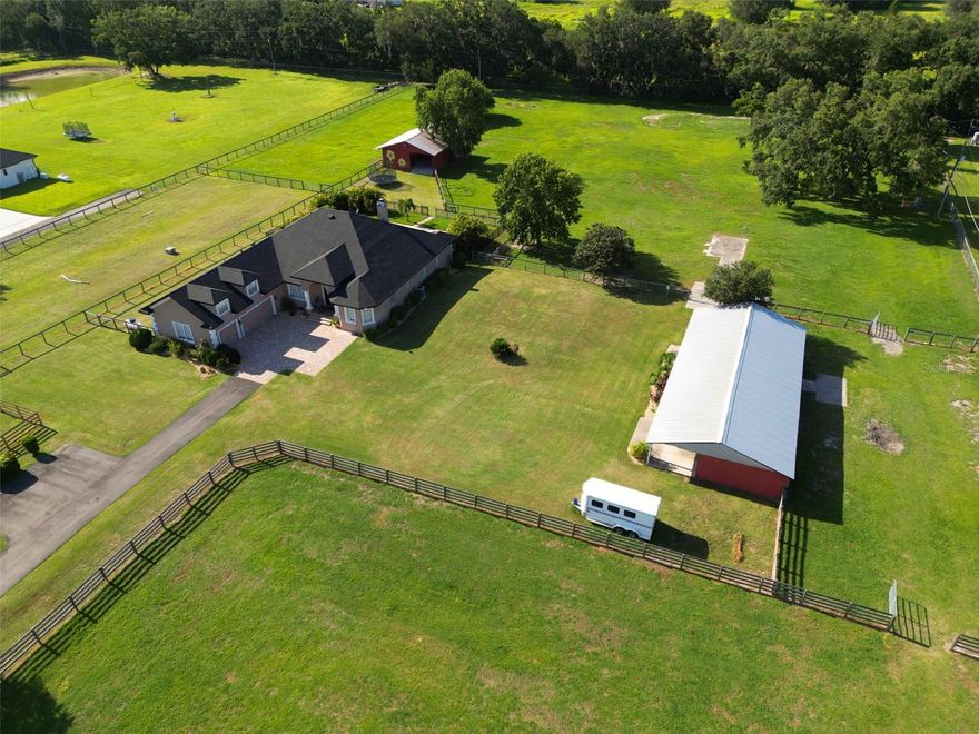 Acreage Lover’s Dream Estate Home With 2 Barns on 4.91 Acres that includes a 4BR, 3.5 baths, 3 car garages and 2 Barns & 4 Pastures And a Heated Salt Pool !  Or could be a great property for Equestrians or your car collection or toys too!  Also for car enthusiasts, we are a hop skip and a jump to Circuit Florida too!

Set on nearly 5 acres, this beautifully updated property offers the best of country living with modern comfort. The spacious 4-bedroom plus bonus office, 3.5-bath home including a 3-car garage is complemented by a heated saltwater free-form pool (2020) with built-in table in the pool for in-pool dining is perfect for entertaining or unwinding. A fenced pool area with child safety gate and additional separate fenced pet run adds convenience and peace of mind. And Roof was replaced in 11/22!

Equestrian facilities and pastures are thoughtfully designed and ready for your horses include Two barns with 3 stalls, an additional large open stall, tack room, feed room, and barn storage.  Barn 1 size 40x30 Barn 2 size 68x30

Four well planned fully fenced pastures for grazing and rotation, Secure wood and post horse fencing throughout with the majority of which includes no-climb wire fencing.

This move-in ready equestrian retreat combines practical updates with resort-style living. Whether you’re looking for a working farm, a horse-friendly homestead, or a peaceful retreat, or just a place to enjoy your toys, this property checks every box !

For Internet, Spectrum is on site AND very shortly ( within weeks) Frontier fiber will be on site too ! 

Plus an excellent location in North Auburndale, the gem of Polk County !  Easy access to I4, the Polk Parkway, Lakeland, Winter Haven and an excellent location in between Orlando and Tampa with super access to all the Disney parks, Universal Parks and SeaWorld too !  Added bonus is typically 50-55 min to Orlando's MCO airport !