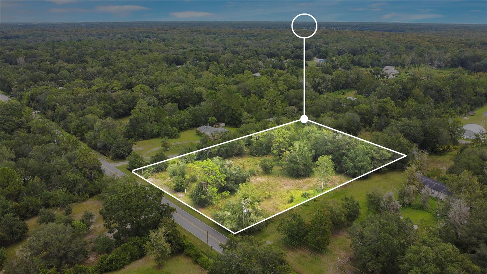 Discover your private slice of countryside charm on this 2+ acre fully fenced parcel in Southeast Orlando’s coveted 32828 area, perfect for building your dream home, bringing horses, or establishing a mini-farm. Located at the end of a peaceful dead-end street, this property features mature oak trees, a decorative wrought iron gate, and a small horse shelter already in place, offering tranquility, character, and functionality. Zoned A-2 with no HOA restrictions, residents can keep up to one horse per acre. Surrounded by a green conservation buffer, the lot feels tucked away, yet remains highly accessible—just minutes from University of Central Florida, Waterford Lakes, Avalon Park, Orlando International Airport, and Cocoa Beach/Port Canaveral. This location is ideal for families seeking both rural living and educational convenience. Whether you're envisioning equestrian facilities, a sprawling estate, or your very own homestead, this versatile property promises both peace and potential.