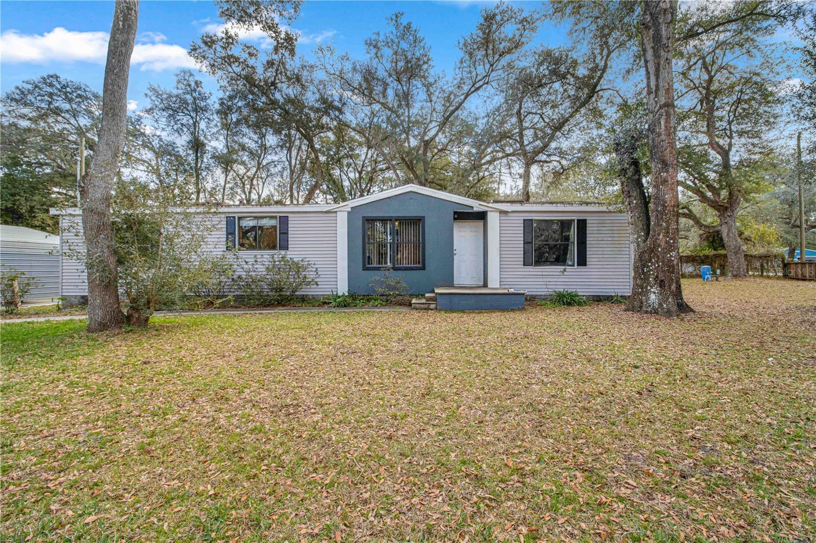 Brand new roof installed 3/2/2023! Bring your toys! CASH SALE ONLY. This spacious SPLIT BEDROOM home is on a CORNER lot, FENCED with 3 drive gates, and has plenty of room for your toys. Inside the fence you will find a double carport, a nice shed, and a 20'x20' SHOP. The shed and shop are both wired with electricity, and there is an electric hookup and septic connection for your RV. Upon entering the front door, you are greeted with a large combination dining and living room. Both rooms have built in features, and the living room includes a wood burning FIREPLACE for those colder nights. To the right is the large master suite, with walk-in closet and master bath. The master bath includes a tub and separate shower, plus a makeup vanity. Going out of the master and across the dining area leads you into the kitchen, which has its own ceiling fan and space for a small table. To your right off of the kitchen is a SPACIOUS PANTRY closet, a mud room or space for a large freezer, and INSIDE LAUNDRY just before the back door. Going back into the kitchen, you will find a short hall to your right that leads to the additional bathroom, as well as the other 2 bedrooms, which are also good size. Upon exiting the back door, you will find yourself standing on a 16' x 18' wooden deck that is ready for your above ground pool to be installed! Live the complete SALT LIFE with plenty of space for your RV, boats, ATV/UTV, motorcycles, or such while enjoying the peaceful country lifestyle. Add the pool for your own personal oasis! Schedule your appointment to see this one!