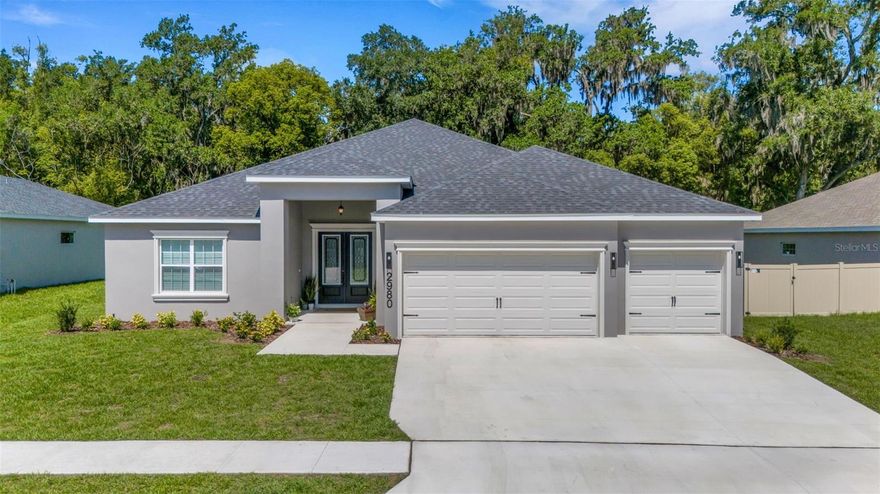 Welcome to Keen’s Grove, a boutique North Lakeland community offering just 25 exclusive homes on spacious ¼-acre homesites. This impressive Willow II by Highland Homes features 5 bedrooms, 3 bathrooms, 2,956 heated square feet of living area, a triple-split floor plan, and a flexible second-story loft space—all thoughtfully designed for comfortable everyday living.

A grand double-door entry welcomes you into a light, bright, and spacious great room/kitchen combination, perfect for gathering and entertaining. Luxury vinyl plank flooring flows throughout the home, complemented by soaring 9'+ ceilings, elegant 5" baseboards, upgraded black door hardware, and updated black light fixtures that add a modern designer touch.

The open kitchen is both stylish and functional, featuring a large counter-height butterfly island, pantry, casual café dining area, quartz countertops, upgraded induction range, and seamless flow into the main living space. Formal and casual dining areas provide flexibility for both everyday meals and entertaining.

The spacious owner’s suite offers an elegant tray ceiling, oversized walk-in closet with double shelving, and a spa-like ensuite bath featuring dual vanities with quartz countertops, an oversized tiled shower with tile extended to the ceiling, linen closet, and private water closet. Bedroom 5 and Bath 3 offer excellent potential for an in-law suite or private guest retreat.

Upstairs, the loft/studio/theater room provides exceptional versatility and could easily function as a 6th bedroom, media room, home office, playroom, or bonus living space.

Enjoy Florida living from the covered 9'x20' lanai with upgraded French doors and convenient access from both the gathering room and Bath 3, creating the perfect future pool bath setup. The private backyard offers peaceful views and plenty of room to add the pool of your dreams.

Additional highlights include an oversized three-car garage with storage area, inside laundry room with cabinetry, irrigation system, upgraded front entry doors, quartz countertops throughout the kitchen and bathrooms, tile extended to the ceiling in all bathrooms, double shelving in all closets, and energy-efficient dual 17-SEER A/C systems for enhanced comfort and efficiency.

Keen’s Grove offers a peaceful semi-rural setting with modern convenience—less than 2 miles to I-4, close to US-98, shopping, dining, parks, recreation, healthcare, and downtown Lakeland. With no CDD and only 25 homes in the community, this is a rare opportunity to enjoy spacious living in a desirable North Lakeland location!  **Note taxes are on the lot only***
