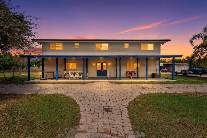 Welcome to 8360 SW Easy Street in Arcadia * where space, flexibility, and country privacy come together on approximately 1.5 acres with no HOA.

This attractive two-level home offers 3 bedrooms and 3 full bathrooms with a layout well suited for multi-generational living, guests, or flexible use. The lower level features a primary bedroom and full bath, private patio access, and entry to the attached garage. Upstairs, you’ll find the main living area including the kitchen, living and dining spaces, plus two additional bedrooms with baths.

The kitchen is equipped with granite countertops and a breakfast bar, opening to a spacious living area with an alcove ideal for formal dining, a reading nook, or den space. The upstairs primary suite includes a large walk-in shower and dual sink vanity, while the additional bedroom offers a tub/shower combination and single vanity.

Enjoy peaceful views from the back deck overlooking the property, shaded by mature trees that enhance both privacy and natural beauty. All windows are double-pane, the well has been updated, and the home was originally designed with space allocated for a future elevator installation if desired.

Outdoor features elevate this property even further:
-New metal roof
-36' x 52' detached garage/workshop
-6-inch concrete slab
-14' x 10' roll-down door
-Oversized vehicle lift included
-Circular paver driveway and walkways
-Covered entry

Detached approximately 700 sq ft climate-controlled flex space ready for customization.

The expansive lot offers ample room for additional outdoor features such as a pool, cabana, garden, or recreational storage.

Conveniently located within approximately 20 minutes of I-75, Punta Gorda, and Downtown Arcadia, this property provides country living with access to regional amenities. A neighborhood convenience store is located nearby for everyday needs.

This property is ideal for buyers seeking acreage, workshop space, RV/boat storage potential, multi-use flex areas, and privacy without association restrictions.

Schedule your private showing and explore the possibilities at 8360 SW Easy Street.