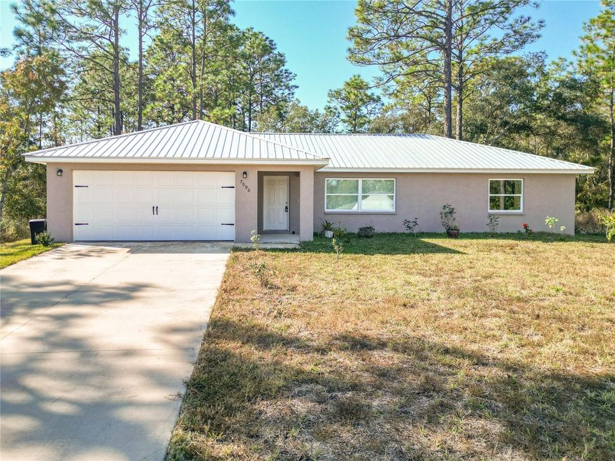 THIS 2024 HOME IS PRICED TO MOVE! 3 beds 2 bath 2 car garage. Why deal with construction delays and upgrade costs when this nearly new Citrus Springs home has it all? Located on a quiet paved road, this home features today's most popular finishes, the vaulted ceiling in the spacious living area creates a bright, open feel, while the modern kitchen boasts stainless steel appliances, with beautiful dark cabinets, and stunning granite countertops. Durable luxury vinyl plank flooring runs throughout the home. Master Bedroom with walk in closet and master bath has granite countertops and a tile walk in shower.  The two additional bedrooms are located on the opposite side of the home which provides added privacy. The second bathroom also has granite countertops and a shower/tub combination. Centrally located with a short drive to Crystal River, Dunnellon, and Inverness which provides plenty of shopping, entertainment, and medical facilities. it's also not far from the Suncoast Parkway which provides easy access to Tampa. Call to schedule your showing today this beautiful home won't last!