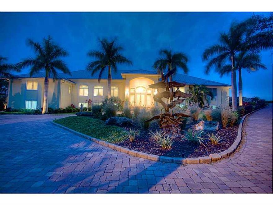 Spectacular direct Intracoastal Waterway 2006 home with recent upgrades that surpass the highest of standards...BEING OFFERED COMPLETELY FURNISHED AND MORE! Interior upgrades include: hardwood living room flooring, hurricane glass panels off the living room for an incredible view of the ICW, and electric, light softening sunshades. Exterior upgrades include: dock upgrades, 2 lifts (1 covered), tropical landscaping, and much more. The main living area encompasses over 4,200 sq.ft. of luxurious appointments in 4 bedrooms 3.5 bathrooms and an additional 4,000 sq.ft. in entry, pool, lanai, and garage space. Enter this point property via the brick paver driveways around the home, through the beautiful grounds. The home features a multi-zoned HVAC, a walk-in safe, central vac system, spacious enclosed pantry, fireplace, an elaborate living room wet bar and maximum storage throughout! Granite surfaces are featured throughout, stainless appliances, maple doors, cabinetry and built-ins accentuate multiple areas. Various flooring includes: bamboo in the kitchen & dining room, marble in the breakfast/lunch area & bathrooms, and carpet in the bedrooms. Phillipinno shell stone flooring covers the main living area out and onto the pool deck. Outdoor features include: outdoor grill, dockside fire pit, and a solar heated pool. The lower level is an additional 7,000 sq.ft. utilized as additional garage and storage space with a game room & tackle room.  One of Placida's most spectacular homes.