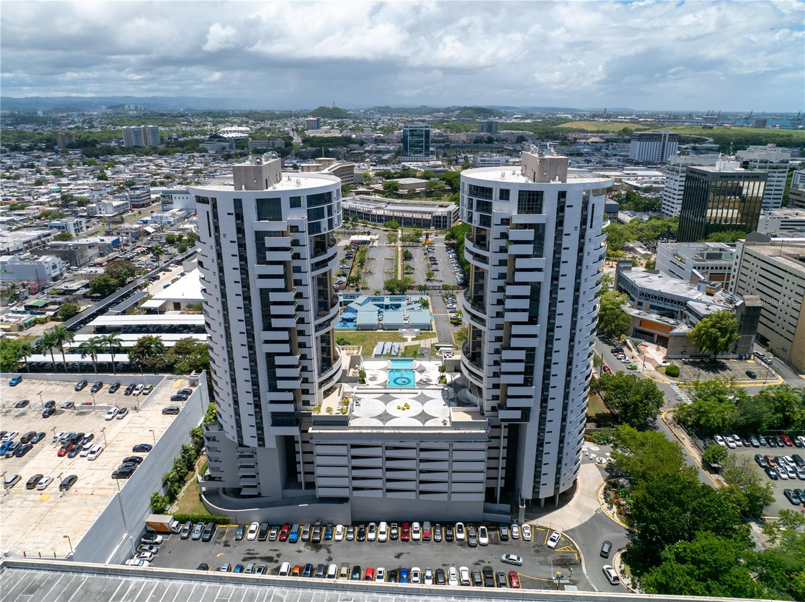Luxury City Living at Quantum Metrocenter – Hato Rey, San Juan Live in the heart of Puerto Rico’s iconic financial district, La Milla de Oro, at the well-known Quantum Metrocenter, one of the tallest and most luxurious residential towers on the island. This stunning 1,936 sq. ft. apartment features an open-concept layout with 2 bedrooms, 2 bathrooms, and the flexibility to convert a spacious family room into a third bedroom. Floor-to-ceiling windows and an expansive balcony allow you to enjoy panoramic views of San Juan’s dynamic skyline, bringing natural light and urban elegance into every corner. The home boasts a beautifully appointed master suite with a walk-in closet and a spa-style bathroom, complete with dual vanities, whirlpool tub, and a separate shower. Additional highlights include a modern kitchen, formal dining and living areas, an office space, a functional laundry room, and soaring ceilings with top-of-the-line finishes throughout. Quantum Metrocenter offers an unmatched lifestyle with world-class amenities, including: Resort-style pool, jacuzzi, and solarium State-of-the-art fitness center Movie theater, activity center, and meeting rooms Dog park, playground, and outdoor kitchen Elegant lobby, 24/7 security, and closed-circuit surveillance Full electric generator and water cistern ensuring uninterrupted comfort 3 elevators in each tower for optimal convenience This is urban luxury at its finest—a rare opportunity to live in one of San Juan’s most exclusive high-rise residences.