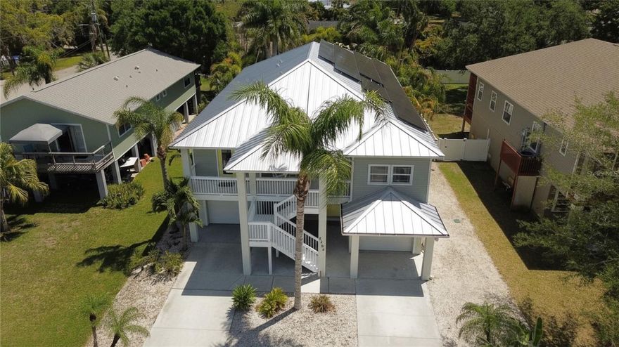 This elevated key west style home is located just steps from the Gulfport Beach and Arts District which has many amazing restaurants, shops as well as events and festivals. The property itself features 3 large bedrooms and 3 full baths with two of the bedrooms having en-suite baths. A very open floor plan lends itself to entertaining with its spaciousness. The living room, as well as the Master Bedroom opens to the nice sized upper rear deck overlooking the resort comparable pool, patio area and professionally landscaped fenced rear yard.
The lower level of the property has a split garage, an entry leading to an interior foyer area with interior stairwell, with the rear area is currently configured with a large game room which also opens directly on to the expansive patio area and beautiful pool.
This amazing property also features a newer (2 years old) standing seam metal roof as well as owned solar panels to keep the energy costs reasonable for years to come. Also a very reasonable and assumable flood policy which the current premium is $516.00 annually. This wonderful property has been professionally staged and must be seen to be appreciated.