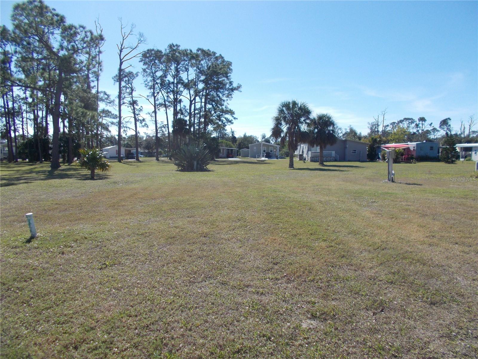 VACANT LAND in the sought after Gated Community of Holiday Park and NOT IN THE PET SECTION. The land is located on Hauli Court, in the cul-de-sac and is 6921 square feet. It sits between 2 new homes. In Holiday Park you own the land with a deed and the maintenance fee $2340.00 a year ($195.00 a month) is included in your taxes. Holiday Park offer many amenities including 2 Pools, Tennis Courts, Pickle Ball, Bocci, Shuffleboard, Laundry Library, Horseshoes, Bingo plus other card games, Fitness Room and so much more. This home has been pulled off and electric and water are in place. This is a perfect place for your new manufactured home. Come and see!