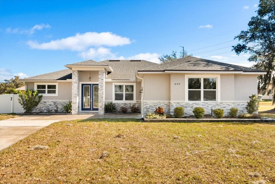 Welcome to 840 Oaks Shores Rd—a move-in ready retreat in a quiet, gated community where life slows down and the lake lifestyle speeds up. With private access to Lake Griffin, your weekends can be filled with boating, fishing, and sunset cruises—while everyday life feels like a vacation surrounded by Central Florida’s natural beauty. Inside, enjoy a light, open layout made for connection and entertaining, featuring an open-concept kitchen with quartz countertops, 42" stylish gray custom cabinetry, and stainless steel appliances, flowing seamlessly into the living/dining combo. Thoughtful upgrades like ceramic tile throughout for easy maintenance, tray ceilings, and crown molding add comfort and polish. Step out to the covered lanai—perfect for morning coffee, evening wind-downs, and hosting friends. Situated on a spacious corner lot, there’s plenty of outdoor room to play, garden, or create your dream backyard oasis. Enjoy the best of both worlds: peaceful, scenic living with convenient access to shopping, dining, parks, and all that the Leesburg lakefront area has to offer.