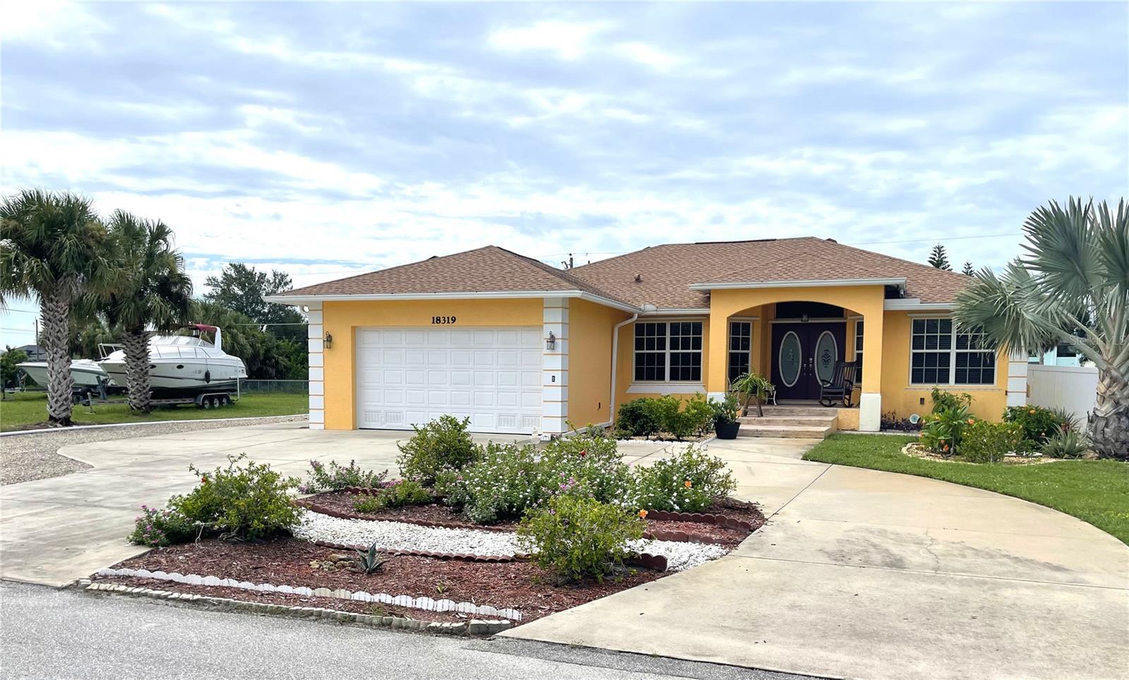 **PLEASE ENJOY THE 3D INTERACTIVE VIRTUAL TOUR ASSOCIATED WITH THIS LISTING - Looking for a Single-family home with an adjacent cleared lot and almost 1/2 acre of land? Then look no further than this 3 bedroom, 2 bath home with stainless steel appliances, breakfast bar and sizable pantry for the cook in your family. The Primary Bedroom/ Bathroom includes a walk-in closet, dual sinks, linen closet, large walk-in shower and accesses the screened lanai where your hot tub awaits! The front bedroom is currently being used as an office. The guest bathroom has a tub/shower combination including linen closet. The laundry is off of the garage and includes laundry tub and shelves. Additional features include built-in gas fireplace in the great room, hurricane shutters, central vacuum, tile floors, high ceilings, ceiling fans, Manibloc plumbing system, new roof in 2023 with solar panels resulting in low electric bills, well for irrigation system, circular driveway and cleared adjacent lot which includes storage shed and an additional parking area too! Plenty of room to park your RV, add a garage or completely fence for your all of your toys! Just minutes to Historic Downtown Punta Gorda, Sunseeker Resort, Charlotte Sports Park and boat ramps off of Edgewater Drive with easy access to 41 (Tamiami Trail) and Interstate 75. Schedule your private showing today!