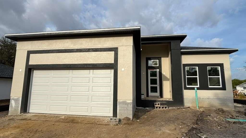 Photo of 310 Millport Street NW, Port Charlotte, FL 33948 (MLS # O6359819)