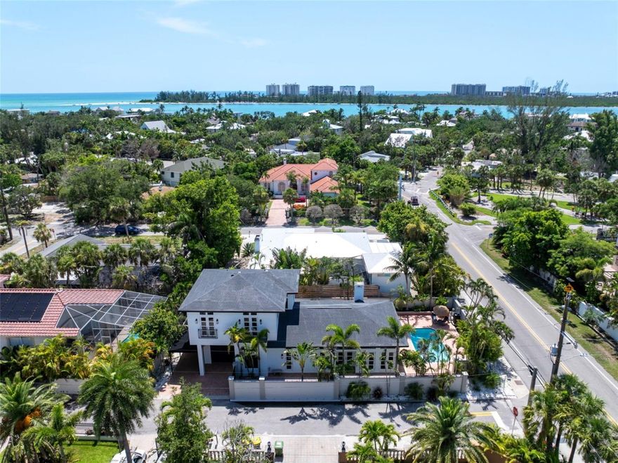 One or more photo(s) has been virtually staged. Welcome to the #1 beach in the US and top 50 in the world- Siesta Key, FL. Whether you're seeking a primary residence or a high-performing Airbnb investment, this fully renovated 5-bedroom, 4-bathroom coastal contemporary pool home offers the best of both worlds! Ideally situated on an oversized corner lot on Siesta Key and located within city limits, this MOVE-IN READY gem legally qualifies for 7-day minimum rentals, making it a prime opportunity for full-time living, or a lucrative short-term vacation rental. Nestled behind a grand privacy wall, this unique masterpiece provides a true tropical retreat for you and your guests. From the moment you step inside, you'll be captivated by the soaring 12-foot ceilings on both levels, the open concept floor plan, and elegant travertine marble flooring throughout. The primary suite is conveniently located on the first floor, offering both comfort and privacy with French doors that lead to your outdoor private patio. Custom hurricane-impact French doors wrap the entire main living area, seamlessly blending indoor and outdoor spaces, creating a dramatic view of your tropical oasis. Enjoy peace of mind with HURRICANE-IMPACT WINDOWS and DOORS installed throughout the home. Ample on-site parking for up to 5 vehicles adds exceptional convenience for both owners and guests. The chef’s kitchen is fully equipped with high-end finishes, including a gourmet gas range and hood, custom wood cabinetry, quartz countertops, an oversized BLANCO sink, and wine cooler, perfect for hosting and entertaining. Some of the recent upgrades include two brand-new HVAC systems (one for each level), new hot water heater, all new appliances, fresh interior and exterior paint, new landscaping and irrigation, and new electrical wiring and plumbing complete with a convenient manifold in the garage for your shut off valves. The newly resurfaced pool, paired with new pool equipment, invites you to relax in total serenity. Surrounded by lush, tropical landscaping, the spacious outdoor area offers plenty of room to entertain guests or simply soak in the Florida sunshine in total privacy. This residence is located just four blocks from the nearest beach access at N. Shell Rd, and near the North bridge for convenient access to and from the Key. Take a short ride to the world-famous Siesta Key Beach and Village, where you'll enjoy fine dining, boutique shopping, and vibrant island living. Known for its powder-soft quartz sand, Siesta Key consistently ranks among the top beaches in the United States, making this a premier location for homeowners and investors alike. Call today to schedule your private showing!