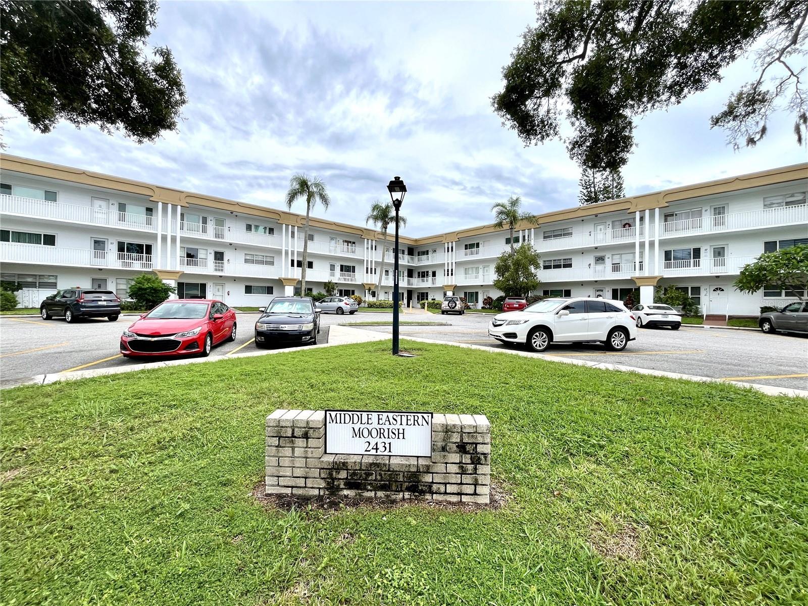 If you are looking for a 1st floor condo walking distance to the East community center with a washer and dryer, you are in luck!!! This 2 bedroom condo is located steps away from all your amenities, Featuring pool, tennis courts, pickleball, lawn bowling, shuffleboard, fitness center, recreation center, etc. This condo features updated kitchen cabinets and hardware. Updated countertops, stove and microwave. The Florida room features built in desk and cabinets. The front and back of the condo have spacious patios for your outdoor enjoyment. The bedrooms are spacious with plenty of closet space. Updated windows and updated bathroom vanity and tile. Schedule your showing today. Assigned parking. The 55+ community has two activity centers, and two private golf courses with 9 and 18 holes, free exclusively for resident owners. There are two heated swimming pools. The remodeled Cardio Gym has the latest exercise equipment. A very pet-friendly community, there is a fenced dog park with covered seating. There are hobby studios, and a wood shop for the exclusive use of the residents. Activities include fitness classes, dancing, clubs, cards, billiards, entertainment, classes, and much more. The on-site Good Karma Café has take & bake meals and snacks. Close to beaches, transportation, shopping, entertainment, and fine dining. All room sizes, floor plans and square footage are approximate.