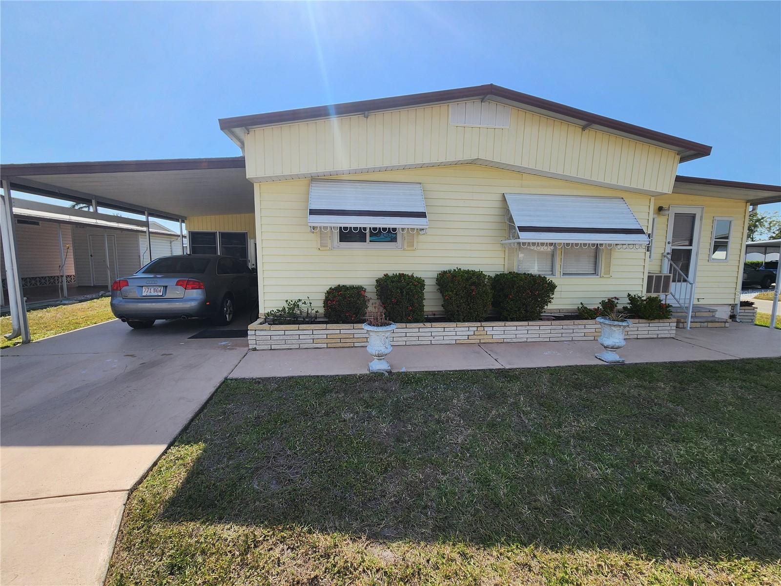 Welcome to Palm Lakes Estate – a vibrant 55+ active community! This charming furnished corner lot home features 2 bedrooms, 2 bathrooms, and an open-concept kitchen, plus an additional room currently used as a 3rd bedroom with its own private entrance – perfect for guests or a home office. Enjoy spacious walk-in closets, his and hers sinks in the primary bath, and the potential to make it your own with a few updates. Low-maintenance living at just $225/month, which includes water, sewer, trash, cable, internet, pool access, and on-site management – and best of all, NO LOT RENT! Conveniently located near shopping, restaurants, the airport, and beautiful beaches. Whether you're looking for year-round living or a seasonal escape, this home is the perfect Florida retreat.