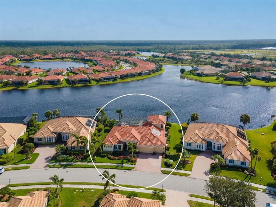 The moment you approach this elegant home you will note the grandeur of its columns and welcoming entrance.  Situated on THE prime lakefront site, you will be held in awe by the infinity saltwater pool disappearing into the expansive lake’s widest point. Sit, relax, enjoy and contemplate life!  This Da Vinci I model with upstairs bonus room also features 4 bedrooms, 3 baths, 3 car garage, a reader’s library with custom built cabinetry, a master suite with reading/lounge area, a formal living room, dining room, family room with wine cooler cabinet, a gourmet chef’s kitchen, and a grill master’s outdoor kitchen. Grandly situated, most rooms overlook the spacious lanai with boundless views of the heated infinity pool, spa, and lake.  The pool and spa are heated by a choice of systems depending upon the need: New Roark Solar panels (new 2023), an electric heat pump and a gas heater (new 2022).  The chef’s kitchen features granite countertops, cook’s island, breakfast bar, 6 burner gas stove top, a Luxury GE Monogram 42” Side-by-Side Refrigerator, an Advantium oven/microwave, convection oven & warming tray (New 2019), a very handy free-standing ice maker and two state of the art Bosch dishwashers. The adjacent breakfast nook boasts grand aquarium windows with sweeping views of the infinity pool and lake.  The expansive master bath features a Jacuzzi tub, double headed shower, tile accents with complimentary granite countertops and double sinks.  This home lacks nothing and includes either electric hurricane shutters or impact windows throughout along with a Generac whole house gas generator.  Features also include a barrel tile roof, custom wood working, a central vacuum system, tankless water heater, two air conditioning systems, crown molding, tray ceilings, Bahama shutters, recessed lighting and many rooms with ceramic tile & mosaic inserts laid on the diagonal.  The River Club boasts amenities and social events for all to enjoy including a restaurant, club room, a grand heated pool, a lap pool, tennis courts, workout room and a boardwalk down to the river.  The Golf Club is available with a separate membership and is not a requirement for living in the community. The Venetian Golf & River Club is extremely convenient to all that is going on in the central West Coast of Florida: Beaches, shopping, the arts, the airport. Truly a home to be appreciated.  Come make it yours!