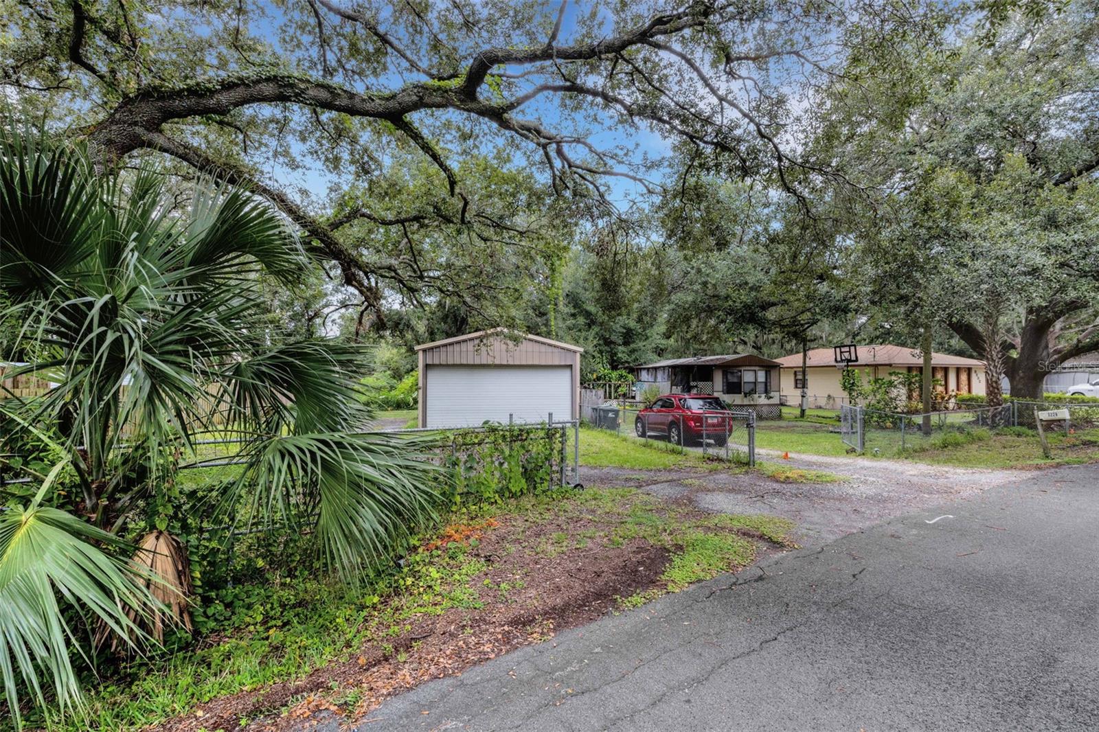Great investment property in North Lakeland! This property is .64 of an acre and has income potential along with personal use written all over it. There are 2 single wide mobile homes - one of them is rented and the other is vacant. In between the mobile homes is a 24x36 massive
detached garage with power that is a great workshop or storage building for your toys. The backyard is also large and has plenty of potential!
Located right off 98 North and close to I-4 there is unlimited potential for this property. Cash only as the mobile homes cannot be financed
because of age and size. Call to see this investment today!!