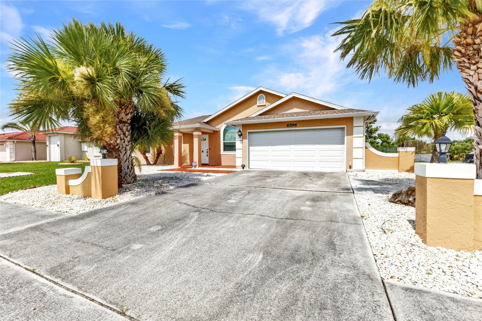 Turn-key furnished and beautifully upgraded, this 3-bedroom, 2-bathroom home offers 1,494 square feet of comfortable living space and peaceful freshwater canal views in the desirable Gardens of Gulf Cove. Built in 1988 and thoughtfully updated throughout, the home sits on a generous 10,001 sq ft lot with a fenced backyard and no rear neighbors, creating a private and serene setting.
A long list of recent improvements ensures lasting value and peace of mind. A new shingle roof was installed in 2023, a fully enclosed Florida room addition was completed in 2020, and hurricane-impact windows were installed throughout the home in 2019. That same year, the home also received multiple new exterior doors, a new garage door, and a fully upgraded HVAC system featuring ductless mini-split air conditioning throughout the entire home—providing efficient, zoned climate control without traditional ductwork. The water heater was replaced in 2022.
Inside, the home is filled with natural light and offers vaulted ceilings, laminate and ceramic tile flooring, and an open-concept layout perfect for everyday living and entertaining. The updated kitchen includes granite countertops, soft-close cabinetry, stainless steel appliances, and a decorative tile backsplash. At the rear of the home, the expansive Florida room adds nearly 400 square feet of bonus living space and is cooled for year-round enjoyment—complete with bar seating, a painted floor, and relaxing views of the backyard and canal.
All bedrooms are located along a central hallway. The spacious primary suite includes an en-suite bath and ample closet space, while two additional bedrooms and a second full bath offers flexible options for guests, office space, or hobbies. The oversized two-car garage features a dedicated laundry area and additional storage. City water is connected.
Located in the deed-restricted community of Gardens of Gulf Cove, residents enjoy access to two amenity centers offering swimming pools, tennis and pickleball courts, shuffleboard, a fitness center, billiards, a library, and more—all for just $470/year. The neighborhood also features sidewalks, scenic lakes, and a welcoming atmosphere just minutes from Englewood Beach, Boca Grande, and all the conveniences of Port Charlotte.
Whether you’re looking for a full-time Florida home or a seasonal getaway, this move-in-ready, furnished property delivers comfort, thoughtful upgrades, and a relaxed waterfront lifestyle.