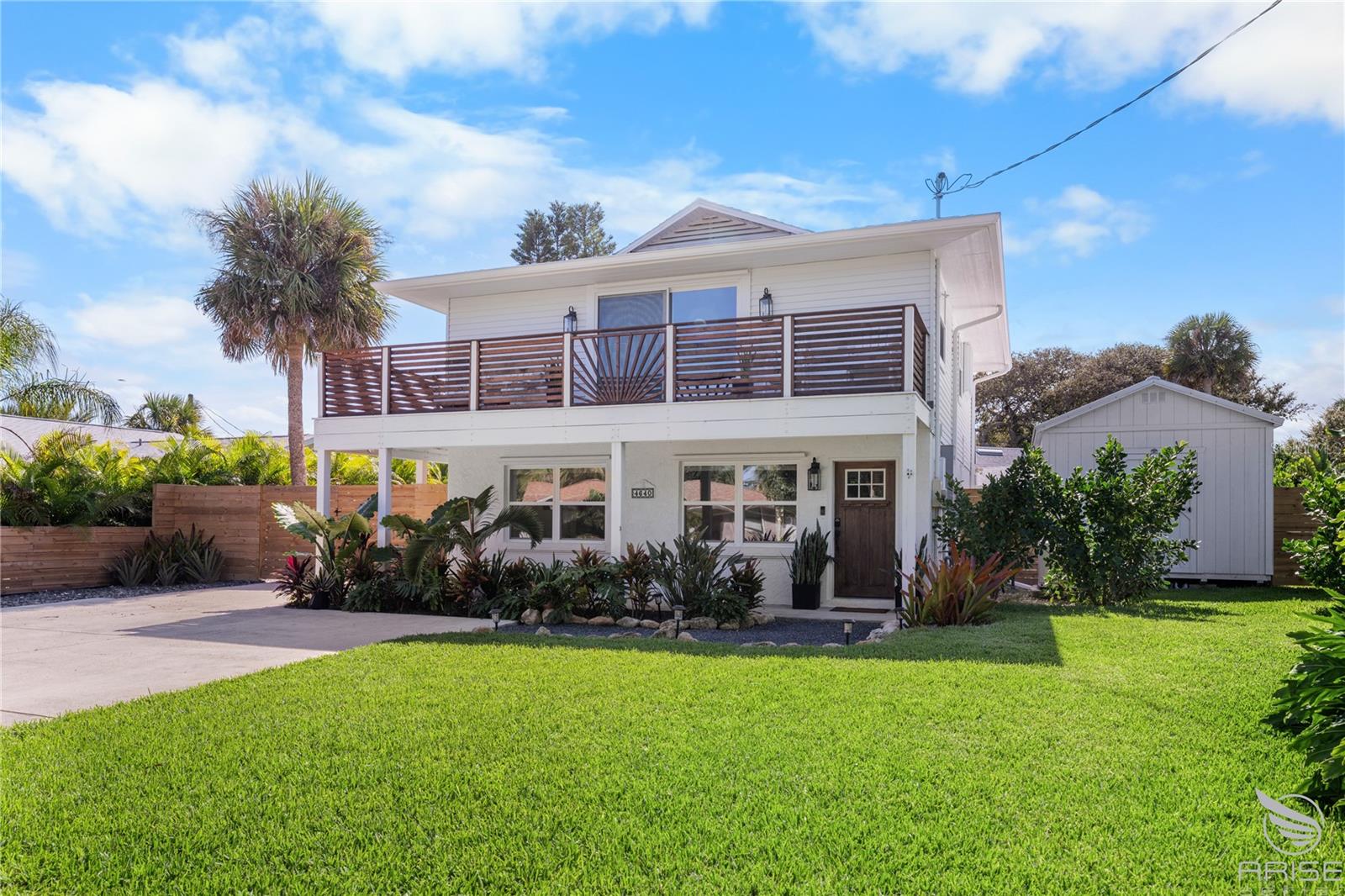 GUEST HOUSE IS 835 SQ FT, 2 BEDROOM 1 BATHROOM AND MAIN HOME IS 1664 SQ FT 3 BEDROOM 2 BATHROOM FOR A TOTAL OF 2499 SQ FT! If you’ve been dreaming of a beautifully remodeled beachside home with a stunning guest house, this is your chance! Located just steps from New Smyrna Beach’s premier white-sand, non-driving shoreline, this property offers the perfect blend of modern comfort, style, and flexibility. The main home has been meticulously reimagined with today’s lifestyle in mind. On the first floor, the foyer has been opened to create a welcoming entry, the full bathroom expanded and finished with modern touches, and a new mudroom added for convenient access to the private courtyard. Two first-floor bedrooms have also been stylishly updated. Upstairs, you’ll find an inviting open-concept living area and an upgraded kitchen featuring quartz countertops, white cabinetry, a large island for gathering, a new pantry, and luxury vinyl flooring throughout. The primary suite opens to a wraparound deck overlooking the lush, tropical backyard—beautifully illuminated at night with landscape lighting. Just beyond the main home sits an impressive 835 sq. ft. two-bedroom, one-bath guest house complete with a full kitchen, spacious living room, and its own private patio—perfect for guests, extended family, or rental income potential. The property’s tropical grounds offer ample room for a pool, generous parking for guests, and a 336 sq. ft. double-door shed with a metal roof. Additional upgrades include tankless water heaters, a whole-home 18kW generator, and thoughtful details throughout. Whether you’re searching for a full-time residence, beach retreat, or multi-generational property, this home stands apart for its design, versatility, and unbeatable location. Now is the time to invest in the lifestyle and flexibility that only this beachside beauty can offer.