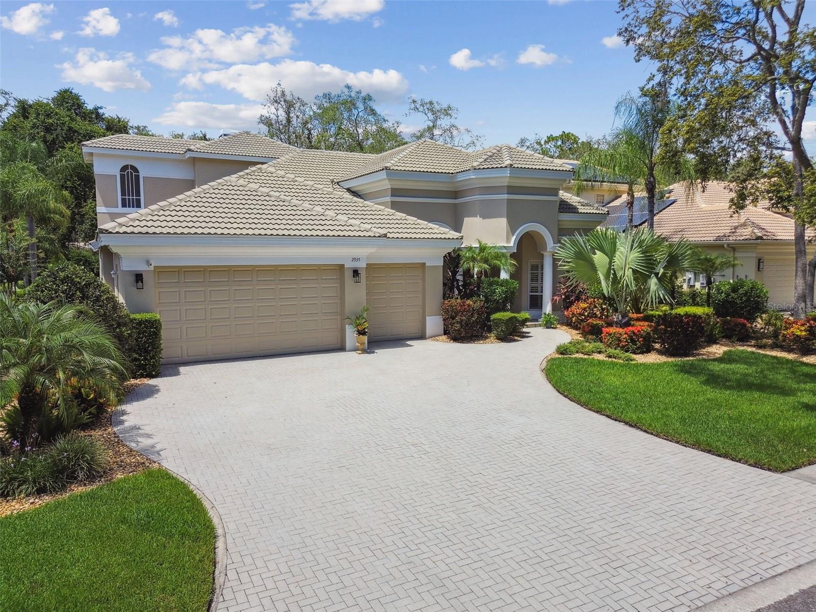 Welcome to Your Private Oasis in the Exclusive Gated Community of Grey Oaks.
This custom-built masterpiece by renowned builder Marc Rutenberg offers timeless elegance, modern comfort, and exceptional craftsmanship throughout. Nestled in the exclusive Grey Oaks community, this home is the perfect blend of luxury and function.
From the moment you arrive, the architectural details signal that this is something truly special. Step through the double glass entry doors and take in the stunning view of the tropical pool and lanai through the expansive 10-foot triple glass sliders.
Soaring 12-foot ceilings with elegant double crown molding set the tone for the refined finishes throughout. Wide plank tile flooring adds a rich, neutral foundation that complements any style. The gourmet kitchen is a showstopper, featuring high-end Thermador stainless steel appliances, including a gas range, double convection ovens, a center island, custom cabinetry with crown accents, and striking Delicatus granite countertops. Enjoy views of the pool through the aquarium glass in the breakfast nook.
The spacious great room includes a gas fireplace and its own set of 10-foot sliders leading to the pool and lanai. The owner’s suite is privately located away from the junior executive bedrooms, offering a serene retreat complete with a spa-inspired master bath.
This home also features two bonus rooms—one located upstairs with its own bath and closet, and another on the main level just off the pool area, lined with windows and centered around a double-sided fireplace.
Located just off Eastlake Road, you’re minutes from Trinity, Palm Harbor, Clearwater, top-rated schools, championship golf courses, fine dining, shopping, and the beautiful Gulf beaches.
Schedule your private showing today and experience the elevated lifestyle that awaits in Grey Oaks.