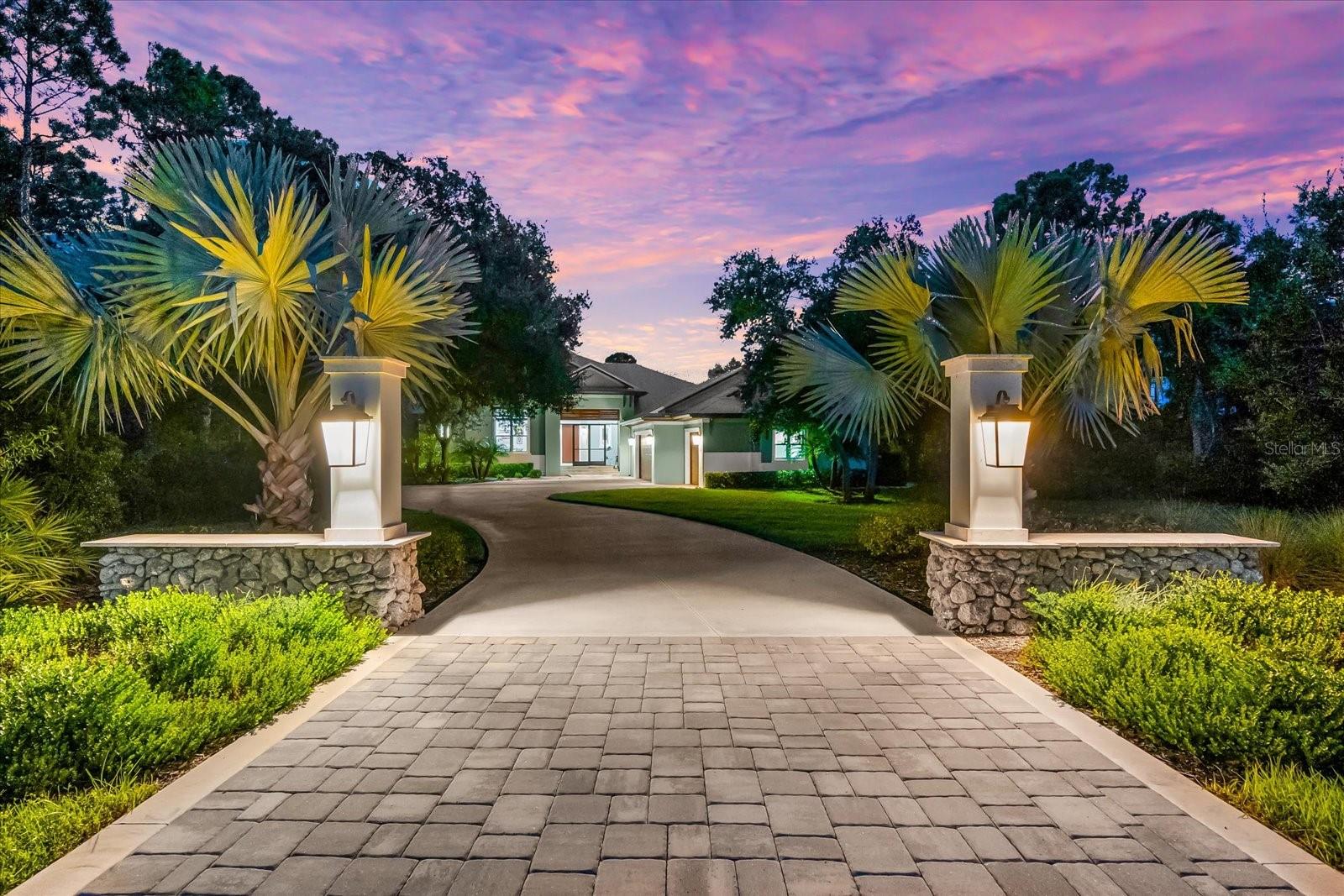 Welcome to 10808 Leafwing Drive, a private 3.64-acre estate in Sarasota’s exclusive gated community, The Forest at Hi Hat Ranch. Designed and built in 2021, this custom-crafted residence—known as The David—is a rare opportunity to experience modern luxury seamlessly blended with the tranquility of nature. Every element of this home was thoughtfully designed to deliver sophistication, privacy, and the finest in Florida living.
The main residence spans more than 5,500 square feet in total, with 3,352 square feet of air-conditioned living space centered around an open, airy floorplan. A dramatic 23-by-34-foot great room serves as the heart of the home, with soaring ceilings, a fireplace, and expansive glass doors that frame peaceful views of Lake Wood and the surrounding conservation land. The chef’s kitchen is equally impressive, featuring custom wood cabinetry, stone counters, top-tier appliances, walk-in pantry, and generous workspace for both everyday living and large-scale entertaining. There are a total of 4 bedrooms - 1 is currently used as an office which has an adjacent bathroom.
The primary suite was designed as a private retreat, complete with a spa-inspired bath featuring a soaking tub, oversized walk-in shower, dual vanities, and a spacious custom closet. Two additional guest suites with walk-in closets and en suite baths lend comfort and privacy. A versatile study with its own walk-in closet provides flexibility as a home office, library, or additional bedroom.
Enhancing the property’s versatility, a detached casita offers an additional 600 square feet with a private bath and kitchenette—perfect for extended family, long-term guests, or multigenerational living.
Outdoor living takes center stage in this estate, with a heated saltwater pool featuring a sun shelf, fiber optic lighting, and an integrated spa. The expansive screened lanai with summer kitchen, outdoor dining, and multiple lounge areas creates a seamless indoor-outdoor lifestyle. Mature landscaping, irrigation system, and private fencing further enhance the serene setting.
Additional features include a four-car garage with carport parking, golf cart and RV accommodations, storm protection, whole-house water filtration and reverse osmosis systems, and energy-efficient design throughout.
Beyond the property, residents of The Forest at Hi Hat Ranch enjoy the rare combination of seclusion and convenience. Just minutes from downtown Sarasota, world-class beaches, fine dining, golf, and cultural venues, this estate provides both privacy and access to everything that makes Sarasota one of Florida’s most desirable destinations.
10808 Leafwing Drive is more than a residence—it is an estate of distinction that offers timeless craftsmanship, luxurious amenities, and an unparalleled Florida lifestyle.