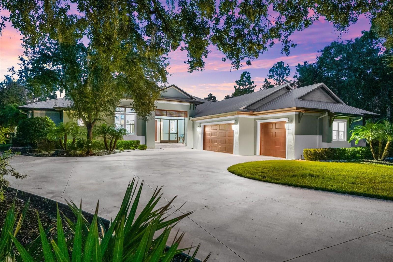 Welcome to 10808 Leafwing Drive, a private 3.64-acre estate in Sarasota’s exclusive gated community, The Forest at Hi Hat Ranch. Designed and built in 2021, this custom-crafted residence—known as The David—is a rare opportunity to experience modern luxury seamlessly blended with the tranquility of nature. Every element of this home was thoughtfully designed to deliver sophistication, privacy, and the finest in Florida living.
The main residence spans more than 5,500 square feet in total, with 3,352 square feet of air-conditioned living space centered around an open, airy floorplan. A dramatic 23-by-34-foot great room serves as the heart of the home, with soaring ceilings, a fireplace, and expansive glass doors that frame peaceful views of Lake Wood and the surrounding conservation land. The chef’s kitchen is equally impressive, featuring custom wood cabinetry, stone counters, top-tier appliances, walk-in pantry, and generous workspace for both everyday living and large-scale entertaining. There are a total of 4 bedrooms - 1 is currently used as an office which has an adjacent bathroom.
The primary suite was designed as a private retreat, complete with a spa-inspired bath featuring a soaking tub, oversized walk-in shower, dual vanities, and a spacious custom closet. Two additional guest suites with walk-in closets and en suite baths lend comfort and privacy. A versatile study with its own walk-in closet provides flexibility as a home office, library, or additional bedroom.
Enhancing the property’s versatility, a detached casita offers an additional 600 square feet with a private bath and kitchenette—perfect for extended family, long-term guests, or multigenerational living.
Outdoor living takes center stage in this estate, with a heated saltwater pool featuring a sun shelf, fiber optic lighting, and an integrated spa. The expansive screened lanai with summer kitchen, outdoor dining, and multiple lounge areas creates a seamless indoor-outdoor lifestyle. Mature landscaping, irrigation system, and private fencing further enhance the serene setting.
Additional features include a four-car garage with carport parking, golf cart and RV accommodations, storm protection, whole-house water filtration and reverse osmosis systems, and energy-efficient design throughout.
Beyond the property, residents of The Forest at Hi Hat Ranch enjoy the rare combination of seclusion and convenience. Just minutes from downtown Sarasota, world-class beaches, fine dining, golf, and cultural venues, this estate provides both privacy and access to everything that makes Sarasota one of Florida’s most desirable destinations.
10808 Leafwing Drive is more than a residence—it is an estate of distinction that offers timeless craftsmanship, luxurious amenities, and an unparalleled Florida lifestyle.