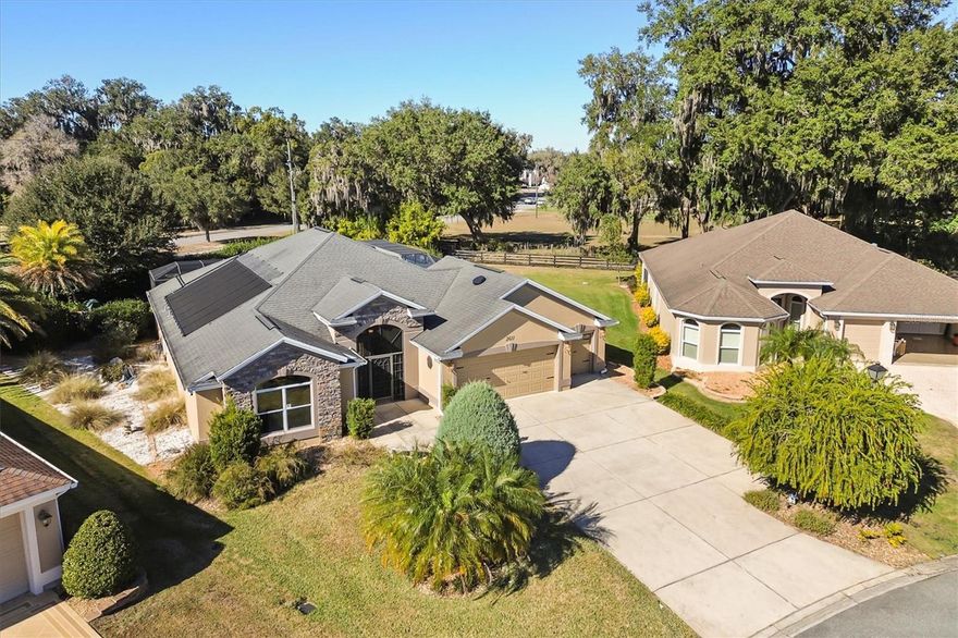Rare privacy in The Village of Collier, conveniently located near Brownwood. This stretched Lantana offers no rear neighbors, with privacy screening that limits visibility from adjacent homes, creating a secluded outdoor setting. Situated on approximately .30 acres, the property includes open green space beyond the pool, enhancing privacy and outdoor use. The expanded lanai is designed for both relaxation and entertaining, featuring a screened enclosure with porcelain tile flooring, retractable solar screens, and a beach-style bar and barbecue area. The designer pool includes a waterfall, solar heat, and app-based controls. A three-person hot tub is privately accessible from the primary bedroom, and decorative birdcage panels add additional privacy. Enjoy Fourth of July fireworks from the Wildwood area from your own pool deck, without leaving home. Inside, the home features thoughtful upgrades and a distinctive design. The expanded and remodeled kitchen includes granite countertops, a copper range hood and sink, along with a built-in wine refrigerator. Crown molding is featured throughout the home, complemented by upgraded ceiling fans, lighting fixtures, and solar tubes. Automated shades are installed on the slider doors in the living area. The primary suite offers lanai access, automatic blackout shades, a walk-in Roman shower, soaking tub, and bidet. Plantation shutters are installed in the front guest bedroom. All windows are equipped with breakage film, with additional solar film applied to select windows. Additional features include a two-car garage plus two golf cart bays, a remote-controlled golf cart screen, and a large attic over the garage for storage. The home includes automated systems for climate control (Ecobee), irrigation (Hydrawise), and pool operation (OmniLogic). Exterior security cameras are installed; monitoring service is optional.