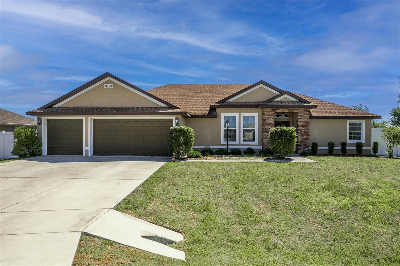 Spacious 4-bedroom, 3-bath, 3-car garage in gated Meadow Glenn in SW Ocala. This beautifully maintained home has 2 master suites, great for family or in-laws. This inviting home features a split bedroom plan, open floor plan. Step inside to soaring ceilings that make the home feel expansive. The generous living and dining area flow together seamlessly into well appointed kitchen with granite countertops, and abundant cabinetry, plenty of space for cooking and entertaining. The spacious primary suite includes a private en-suite bath with soaking tub and walk-in shower, ample closet space, while the additional bedrooms are thoughtfully arranged on the opposite side of the home. Enjoy the convenience of an inside laundry. Huge .40 sized backyard is fully fenced, perfect for pets, play, or simply relaxing. Large slider opens to cozy back porch ideal for morning coffee or evening unwinding. This home truly combines space, comfort and location. Close to new Publix, and SW Ocala shopping and restaurants.