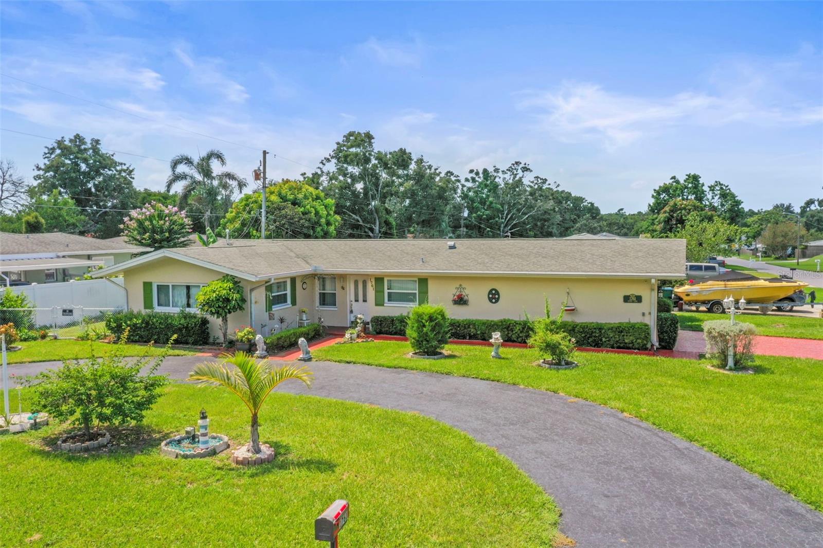 Experience the Florida lifestyle you’ve been dreaming of at 1761 Penny Ln, where every day feels like a vacation. Nestled in one of Clearwater’s most desirable neighborhoods, this rare corner-lot gem captivates from the moment you arrive with its vibrant landscaping, charming curb appeal, and a standout feature rarely found in the area—two driveways, including an elegant circular drive, paired with a roomy two-car garage. Whether you’re entertaining guests, welcoming family, or finding the perfect spot for your boat, there’s space for it all here.
Inside, the open and airy three-bedroom layout invites you to relax and stay awhile. Natural light pours in, highlighting spaces designed for gathering, entertaining, and unwinding. The full bath is complete with a luxurious walk-in Jacuzzi tub—an indulgence you’ll love after a day at the beach.
In the past two years, this home has been thoughtfully upgraded for comfort, convenience, and peace of mind. A brand-new central HVAC system keeps you cool year-round, while custom outdoor light posts add a warm glow to evenings spent on the patio. Unique to this property, you’ll enjoy two water sources—city water for the home and a deep 212-foot spring-fed well dedicated to your garden, landscaping, and irrigation system, keeping your grounds vibrant in every season. Even the essentials have been taken care of, with a new sewer pump and 60-foot drainage pipe recently installed.
Here, you’re not just buying a home—you’re gaining a lifestyle. World-famous Clearwater Beach, vibrant downtown Dunedin, charming local shops, dining, and top-rated schools are all just minutes away. 1761 Penny Ln offers the perfect blend of location, luxury, and rare features that make it truly one of a kind.