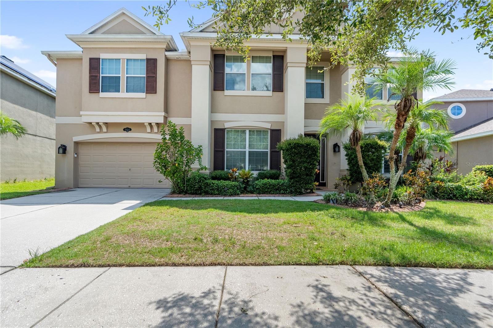 PLEASE REMOVE SHOES WHEN ENTERING HOUSE! Welcome to this spectacular 5+ bedroom, 4 full bathrooms and 1 1/2 bathrooms. 3 car garage pool home on a beautiful conservation lot in the community of Eaton Park. You enter the home into large tiled foyer. With soaring 10' ceilings, fluted casings around all the doorways, and crown molding throughout the home. To the right is a formal living room and to the left is a formal dining room. Continuing forward is the guest 1/2 bathroom with 2 linen closets. You will find wide plank mahogany floors through most of the downstairs room. Then comes a huge family room and kitchen combination. The kitchen has 42 inch cabinets, with crown molding, stainless steel appliances, glass tile backsplash and a HUGE island. There is a butlers pantry between the kitchen and dining room. Enjoy morning coffee in the large breakfast nook looking out the the conservation lot and pool. there is also a large walk in pantry and desk nook. The garage entry can be found here into the tandem 3 car garage. There is a large bedroom with walk in closet. A full bath and door out to the pool area. The pool deck has tumbled pavers, a spa and a gorgeous pool. There is a large covered lanai and incredible deck space. Going upstairs is a large loft space with built in bar with granite countertops, mini fridge and sink. There is a HUGE media room which can easily be a 6th bedroom. The laundry is on the second floor. There are an additional 3 bedrooms Plus Primary bedrooms upstairs and an additional 3 bathrooms. The primary bedroom is grandiose with tray ceilings. Double walk in closets. The primary bath has a soaking tub, dual vanities and separate glass enclosed shower. Enjoy the the outdoors with a wildlife corridor, walking path, swimming pool, playground, parks, and covered pavilion.Close to New Tampa's shopping, restaurants and interstate 75, Easton Park is ideal for commuting to jobs or school. This home is 100% Energy Star tested and certified, an industry best 30 YEAR STRUCTURAL WARRANTY and a builder that is tops in QUALITY with JD Powers makes this home beautiful AND energy efficient!!