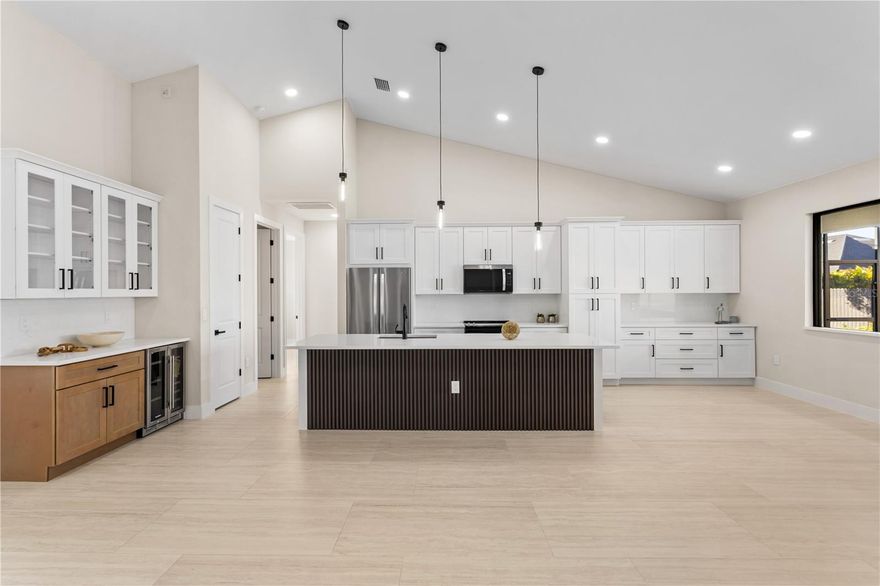 Stop & behold! Move-in-ready NEW CONSTRUCTION HOME - 2026 - complete w/ 2-10 HOME WARRANTY! Located in desirable NORTHERN SW Cape Coral, offers NO FLOOD INSURANCE, durable METAL ROOF, 3-CAR GARAGE & CITY WATER & SEWER! $1,800-$2,400/year homeowners' insurance! Enjoy easy access to CHIQUITA BLVD & PINE ISLAND RD, making commuting & daily errands easier! Designed for MODERN FLORIDA LIVING, this CONTEMPORARY LUXURY HOME features SCREENED, HEATED POOL & SPA, perfect for year-round enjoyment! With 4 BEDS & 3 full BATHS, the layout is ideal for EVERYDAY LIVING & ENTERTAINING! SCREENED LANAI provides PERFECT SETTING TO RELAX in SPA, SWIM in HEATED POOL, or HOST UNFORGETTABLE BBQs while enjoying THE BEST OF SWFL LIVING! Bright, open layout w/ LIGHT NEUTRAL TILE FLOORING throughout. IMPACT-RESISTANT DOUBLE DOORS lead into WELCOMING LIVING ROOM w/ 12-ft VAULTED CEILING & SLIDING DOORS TO LANAI. GORGEOUS CHEF'S KITCHEN w/ SPACIOUS QUARTS COUNTERTOP ISLAND w/ undermount LARGE SINK & SLEEK MATTE-BLACK gooseneck FAUCET. Crisp WHITE SHAKER CABINETRY is paired w/ contrasting warm WOOD-TONE ISLAND CABINETS & modern BLACK HARDWARE for a sophisticated coastal-modern design. Equipped w/ SS appliances, French-door refrigerator, microwave, smooth-top range & dishwasher. Elegant pendant lighting & recessed ceiling lights illuminate OPEN-CONCEPT SPACE, while GLASS-FRONT UPPER CABINETS add touch of ELEGANCE & DISPLAY STORAGE. Built-in BUTLER'S PANTRY w/ quartz countertop, glass-front cabinetry, warm wood base cabinets & WINE REFRIGERATOR, ideal for BEVERAGE STATION, COFFEE BAR, or EXTRA STORAGE & PREP SPACE. DINING ROOM features bright, modern design, neutral tones & vaulted ceiling w/ recessed lighting that enhances the open feel. LARGE PICTURE WINDOW brings in natural light & offers views of screened lanai & backyard. BUILT-IN CUSTOM WHITE CABINETRY provides ADDED STORAGE & CLEAN, UPSCALE LOOK. LARGE PRIMARY SUITE w/ sliding doors to lanai, WALK-IN CLOSET w/ BUILT-IN SHELVING & HANGING RACKS & LUXURIOUS PRIMARY BATHROOM w/ spacious WALK-IN GLASS SHOWER w/ floor-to-ceiling designer tile, rainfall showerhead, built-in bench & modern matte-black fixtures. Dual-sink vanity w/ quartz countertops, sleek white cabinetry & contemporary lighting complements the spa-like design. Private water closet & generous natural light create BRIGHT & SERENE RETREAT! SPLIT LAYOUT offers SECOND PRIMARY SUITE w/ POOL BATHROOM & TWO GUEST BEDROOMS w/ HALL BATHROOM for added privacy. Step outside to SCREENED LANAI w/ HEATED POOL & SPA, landscaped surrounding & FULLY EQUIPED OUTDOOR KITCHEN w/ BUILT-IN stainless steel BBQ GRILL, SINK, BEVERAGE REFRIGERATOR, GRANITE COUNTERTOPS & MODERN BACKSPLASH, ideal for OUTDOOR DINING & ENTERTAINING! PAVER FLOORING & CEILING FAN create COMFORTABLE SPACE for YEAR-ROUND ENJOYMENT. LAUNDRY, 3-CAR GARAGE & long-lasting METAL ROOF complete HOMES' FUNCTIONAL FEATURES. Experience SWFL lifestyle, SCHEDULE YOUR PRIVATE SHOWING TODAY & discover YOUR PIECE OF PARADISE!