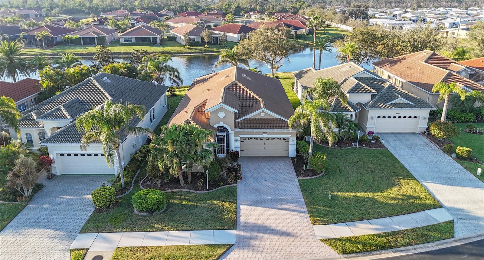 *3D VIRTUAL TOUR* Talon Bay is a very friendly & gated community with 7 lakes, a beautiful club house with resort style heated pool, exercise room, library & large, screened room with a gas grill for entertaining or events. The moment you enter through the gates you will feel right at home! This exceptionally beautiful 2200+ sq. foot home features 4 bedrooms, 3 bathrooms & a 2-car garage with a LAKE VIEW! Pull into the driveway and be impressed with tropical landscaping at front to back including green grass, mulch, curbing, irrigation, palm trees & flowering bushes as you admire your new "home." After the welcoming screened in front porch, open the front door and be impressed by charming archways, high ceilings, rounded corner wall edges & an open floor plan. Ornamental tray ceilings with crown molding line your main living space, with ceramic tile flooring making cleaning a breeze & pet friendly! Any chef would love to cook in this COMPLETELY REMODELED kitchen that boasts a desk area with pegboard to keep track of grocery lists & appointments, CUSTOM SOLID WOOD CABINETS with molding & soft close feature, stone backsplash, under cabinet lights, closet pantry, plant shelves, recessed lighting & glass blocks above the GRANITE countertops that show off a unique prismatic patterned light reflection. Still not impressed? How about the NEW stainless-steel appliances being included in the sale? A well-appointed breakfast bar with new lighting overlooks your open & spacious family room that has a large window allowing the natural light in, if it gets too hot just ask "Alexa" to put down the electric shade! The adjoining dining area with new lighting, is perfect for entertaining guests & enjoying a home cooked meal. Off the kitchen through a pocket door is the transformed custom laundry room, complete with additional storage & coffee bar! A quaint living room is the coziest of spots, this would make a nice reading corner, gathering spot or a peaceful relaxation space. Bedrooms 2 & 3 along with a recently remodeled handicap accessible guest bath, are across the home from the master and they feature ceiling fan, window & private closet. The master suite showcases new carpet, walk-in-closet, dual windows & a bright en-suite bath that features separate dual sinks, make-up vanity, private water closet, shower, linen closet & garden bath. Bedroom #4 and Bathroom #3 are located next to the master bedroom. All the bedrooms are equipped with plant shelves that allow for extra decoration or storage space, and new carpeting! 90 DEGREE SLIDING DOORS allow the outdoors in, step outside & immerse yourself in sunshine, relaxation or entertain with style. The lanai is the perfect spot to birdwatch, dine outdoors or enjoy an evening drink while the clouds reflect from the lake sunsets & a bask of orange, pinks & yellows fill the nighttime sky. Before you go, don't forget to admire the special flooring both in the garage and on the lanai. For added peace of mind, this home features hurricane IMPACT WINDOWS and ROLL DOWN SHUTTERS on the lanai! FLOOD ZONE X - so No flood insurance required! This home is in the section of the HOA that covered by Fidelity, which gives you amazing benefits included such as: New exterior paint every 7 years, irrigation, mowing, roof pressure washing, roof repairs (non-hurricane) & replacement (30 years)! Come enjoy living minutes from Wellen Park, Venice Island, picturesque beaches, top rated golf courses & delicious restaurants.