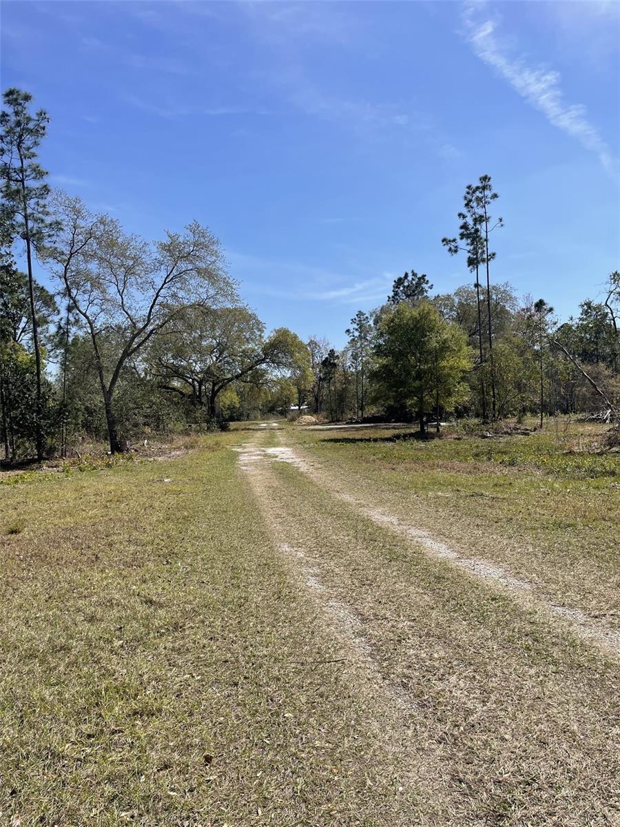 46.25 acres (2 Parcels-2 Building Sites), and two fairly new metal buildings, one is 3480 sqft, the second building is 2100 sqft. This land has several different uses and could be fun to work with. It has AG zoning which is a more relaxed Lake County Zoning. The front of the property has approximately 570' of CR 33 Road Frontage, owner does have a recent survey, 2 separate parcels with 2 building sites contingent upon required setbacks. South parcel with the buildings consists of 34 +/- acres, north parcel with the Island and a fairly new Well would be the 2nd building site, this parcel is 11.66 +/- acres. This land has a good amount of road frontage, a Roadside Farm Stand would be a good use, other allowable uses could be, Agritourism, Bed and Breakfast (home), Plant Nursery, Vet Clinic, Family Day Care, Farming and Livestock use with the AG Zoning. The owner has constructed 2 large metal buildings which offers tons of storage for cars, tractors, boats, equipment. Brand new wire fencing on most of the land. This land is nicely located in Groveland, north of Hwy 50, and not too far from the Florida Turnpike entrances. Major grocery chains, restaurants and shopping are only 5 miles away. This is a very versatile piece of land, the acreage is large, definitely wetlands, but has high and dry land as well. This is a very pretty site, beautiful wildlife, the lake is very serene and private. The Island could make a spectacular 2 acre home site is very private and sits up overlooking the lake. Lake is considered a Grassy Lake, no idea of the depth but definitely fishable. Southern Parcel is 11.66 acres which has the buildings, Northern Parcel is 33.92 acres which has the well and what I call the Island. (Large Barn by the highway does not convey, Lake County confirmed these are building sites, but suitability and setbacks must be verified by the buyer)