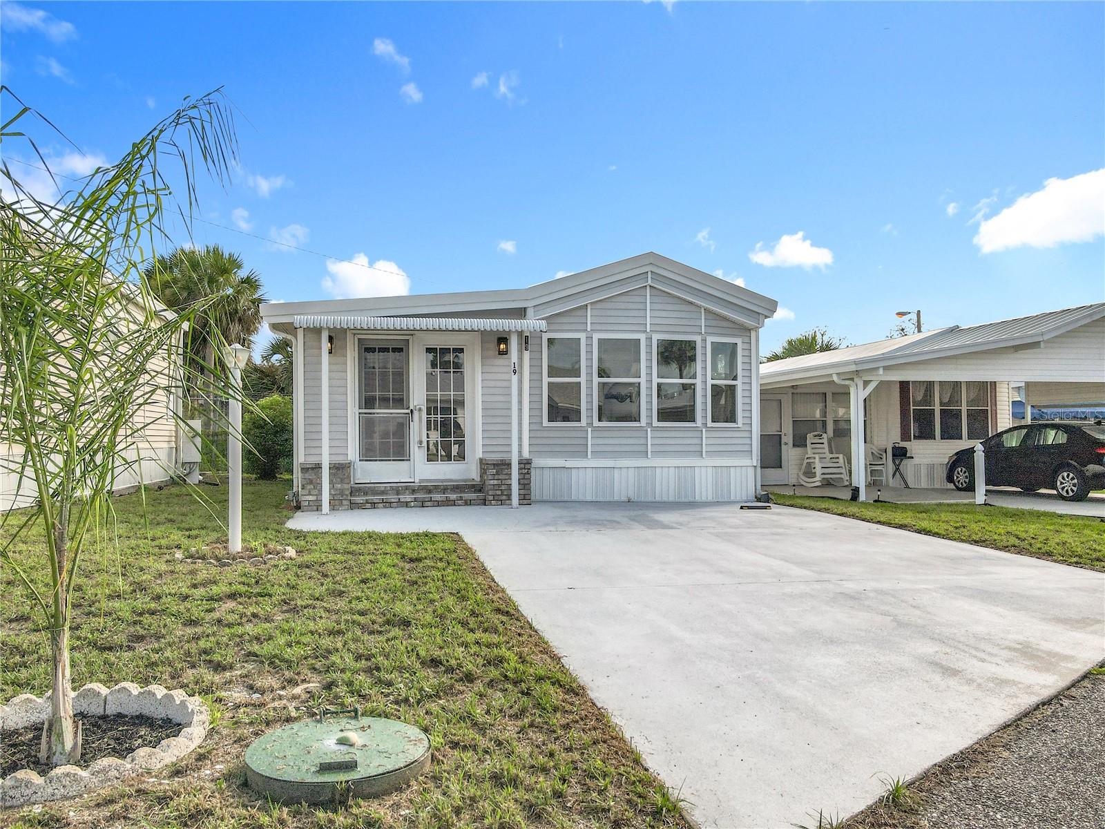 Welcoming curb appeal to this completely upgraded 1 bed, 1 bath move in ready home in the beautiful community of Outdoor Resorts!! Located on the perimeter, the home offers parking for 2 vehicles and features: NEW ROOF; NEW PLUMBING + SINKS & TOILET; NEW DOUBLE PANE WINDOWS; NEW FLOORING & PAINT; NEW COUNTERTOPS; NEW VINYL SIDING; washer & dryer are 18 months old; newer Stainless Appliances and A/C has been fully serviced. A separate laundry room with masses of storage can be accessed from the bedroom and rear door of the home. Property is being sold furnished and equipped as seen. This wonderful resort offers a 24/7 guard gated front entrance and private access to a 197 acre lake - beautiful Lake Davenport. Outdoor Resorts offers amenities such as 2 heated swimming pools, boat dock, golf course & 9 hole putt-putt golf, tennis, pickleball, a two story clubhouse for entertainment during various seasonal events & so much more....The Association fee is only $691.00 PER QUARTER! which includes all your amenities, in addition to Cable TV, Community heated pools, Park Manager, Mowing, Sewer, Water and Trash! Come and enjoy this fantastic, affordable lifestyle! Please remember 55+, no VA or FHA, 1 pet rule. The park benefits from being close to medical facilities, restaurants & grocery stores. Don’t delay!! Put this home on your ‘must see list’ and ask to arrange a viewing today! ****