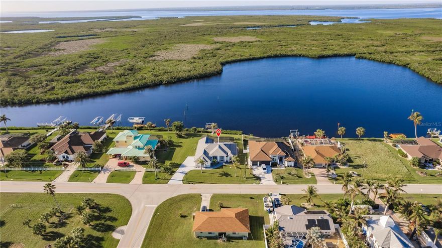 Stunning Waterfront Paradise on the Manchester Waterway - Welcome to your Dream Home! Upon entering this stunning WATERFRONT SAILBOAT
access HOME, you will be greeted by soaring ceilings and an open, airy living space with incredible water views. The living room flows seamlessly
into the family room, perfect for relaxing or entertaining. Just off the living area, the dining room offers a great spot for meals with a view. The
kitchen is a true highlight, featuring beautifully remodeled cabinetry, quartz countertops, and a striking backsplash. It’s equipped with
stainless steel appliances (updated in 2019) and a spacious breakfast bar—ideal for casual meals or coffee with a view. Now, let’s head into the
master suite. It’s a peaceful retreat with two large walk-in closets and a spa-like en-suite bath with dual vanities, a soaking tub, and a walk-in
shower. The best part? The master opens directly onto the lanai, so you can enjoy the soothing water sounds each morning. The other two
bedrooms are spacious and share a beautifully updated full bath. Throughout the home, you’ll notice high-end finishes, like wood plank tile floors, crown molding, and impact windows on the waterside. The home has been freshly painted and offers modern upgrades like a new roof (2021) and remodeled bathrooms (2024). Let’s step outside—this screened lanai is where the magic happens. It's perfect for outdoor living with
panoramic water views, a heated saltwater pool, and plenty of space for lounging. There’s also a half-bath and outdoor shower for added
convenience. The property includes an extra parcel, adding 4,000 sq. ft. for additional space and privacy. Plus, a two-car garage and well for
irrigation make this home as practical as it is beautiful. With its prime location, stunning views, and thoughtful updates, this home offers the
ultimate waterfront lifestyle. Don’t miss your chance—schedule your private showing today!