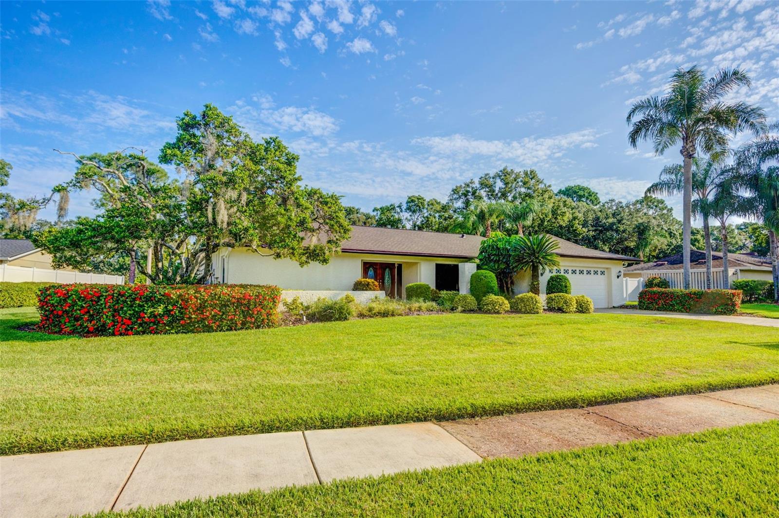 Carrollwood Gem nestled on just shy of a half acre with serene lake views, a beautiful pool and expansive yard! Bring your golf cart and delight in the low annual HOA! This beautifully professionally stage home by Perfectly Placed by Design, boasts 4 oversized bedrooms, living room, dining room and a family room! As you step through the double door entry, you are greeted by the most absolute stunning herringbone wood floors that lead you to the kitchen and family room. The gorgeous living room features sliders which spill out onto the pool deck with an outdoor bar/grill perfect for poolside enjoyment. The formal dining room displays a huge picture window and can dually serve as an office. The master suite is enormous, bright and presents with an elegant en suite bath with separate vanities and walk in closets, walk in shower and exquisite tile and stone! The kitchen is a chef's dream inspired to entertain with stainless appliances, built-ins, gleaming granite counters, rich wood cabinets with glass features and lights, walk in pantry closet, eat-in dining area, 2 bar seating areas- high and counter; the details are countless! The cozy family room has a custom built-in and adjustable wall unit along with decorative ceiling beams and double sliders overlooking the pool. Secondary bedrooms are abundantly spacious, bright and impeccably situated for privacy! The laundry room is extremely functional with washer/dryer, sink, cabinets and space enough to be creative with an additional built in personal feature of your choosing! This home has a brand new roof (Aug 2025) and comes with hurricane shutters! Location, Location, Location: one of Tampa’s most sought-after neighborhoods being just minutes to Carrollwood Village Park, Carrollwood Golf and Country Club, shopping and dining on Dale Mabry, hospitals, and with easy access to I-275 and Veterans Expressway to transport you downtown and to Tampa International Airport in under 20 minutes! This home blends comfort, style, and convenience in one of Tampa’s most sought-after neighborhoods. Roof (2025), HVAC (2023), Water Heater (2022), Pool Pump (2024)