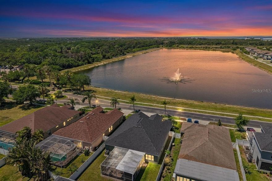 Welcome Home! This charming 4-bedroom, 3-bath, 3-car garage home truly has everything done—located in the gated community of Mira Lago. 
This well-maintained property offers both privacy and a beautiful setting. The front of the home overlooks one of Mira Lago’s expansive ponds with a fountain, creating the perfect backdrop to enjoy Florida sunsets and local wildlife.

The home welcomes you with a screened front entry and double doors. Inside, luxury vinyl plank flooring runs throughout the main living areas, offering both durability and style.

Recent updates provide peace of mind, including a new roof (2025), new A/C (2024), exterior paint (2026), and a water softener system.

Offering 2,472 square feet, the home features a highly functional layout with formal living and dining rooms, an additional den, and an open main living area designed for everyday comfort and entertaining. The kitchen offers ample counter space, a breakfast bar, eat-in dining area, and a closet pantry. The open-concept layout flows seamlessly for entertaining, while bay windows in both the den and kitchen fill the home with natural light.

The owner’s retreat is generously sized and features tray ceilings, a ceiling fan, and an ensuite bathroom complete with a walk-in shower, jetted Jacuzzi tub, private water closet, and a spacious walk-in closet.

All additional bedrooms are generously sized with large closets and ceiling fans. The split-bedroom floorplan provides privacy, making it ideal for guests or multi-generational living.

Out back, enjoy a large screened-in porch and a fully fenced yard—perfect for relaxing or entertaining with added privacy. The oversized 3-car garage provides ample space for vehicles, storage, or hobbies. With LOW CDD and located in an X Flood zone, this home has it all!

Mira Lago is a private, gated community offering a resort-style pool, playground, and basketball court—all just minutes from local beaches, boat launches, shopping, and dining. Easy access to US-41 and I-75 for commuting to Tampa, St. Pete, or Sarasota.