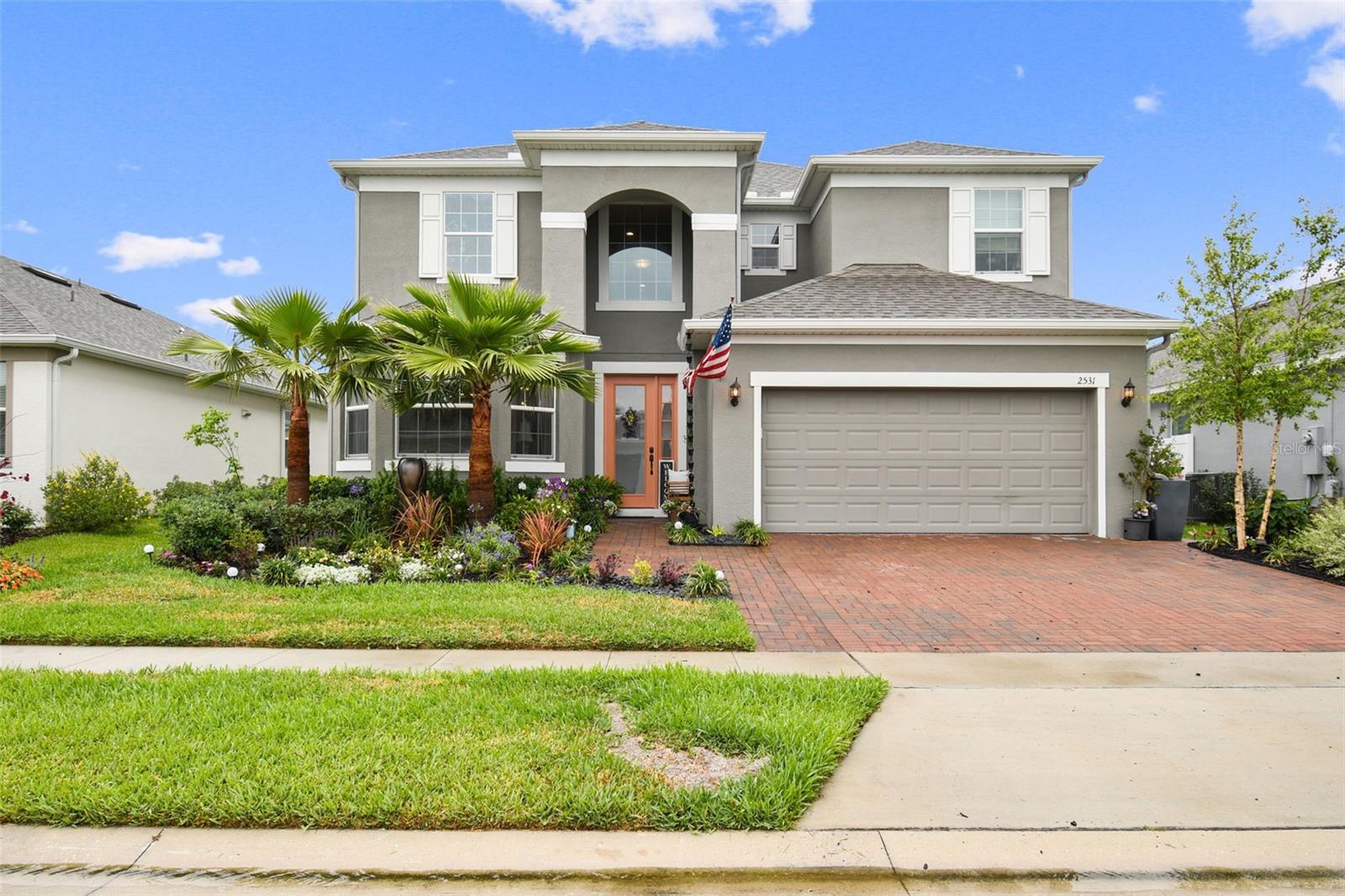 Don’t miss this nearly new home in beautiful Sawgrass Plantation built in 2021 by Park Square Homes. Spacious floor plan features open kitchen/family room with separate dining room and ground floor owner’s bedroom retreat. Luxury vinyl plank flooring in living areas make for elegance and easy care, ceramic tile flooring in all baths and cozy carpet in bedrooms. The interior decor is fresh and neutral to allow easy integration of your own personal taste. First floor den with double doors and bump out window area makes for light and bright home office or craft room. The gorgeous kitchen features 42" cabinets, quartz countertops, stainless, built-in double ovens, dishwasher, microwave, refrigerator, and glass cooktop; perfect complements for easy cooking. You'll love all the cabinet space including built-in pantry. Oversized kitchen island provides large seating area. Adjacent breakfast nook/dinette has a built-in bench. Retire to the owner's suite after a long day and enjoy a relaxing soak in generous tub or invigorating rinse in separate shower. The double sink vanity provides plenty of room to get ready in the mornings. Keep clothing organized with California styled walk-in closet. Oversized laundry room features built in cabinetry and sink. Second story has 5 large bedrooms, three full baths (2 with Jack and Jill configurations) and 2 bonus room/loft spaces, utilized as a second family/media room and a relaxing sitting room bathed in natural light. Prepare to be delighted with fenced, beautifully landscaped back yard. From the oversized, covered patio to the hard scaped paver areas, you’ll be amazed at what you will find (and can grow) in your own private garden oasis. Whimsical garden path with arch trellis and mini “bridge” on east side of house. Conveniently located near shopping, schools, 417, FL Turnpike, Meadowoods SunRail station and so much more. Easy drive to Orlando International Airport and other area attractions.