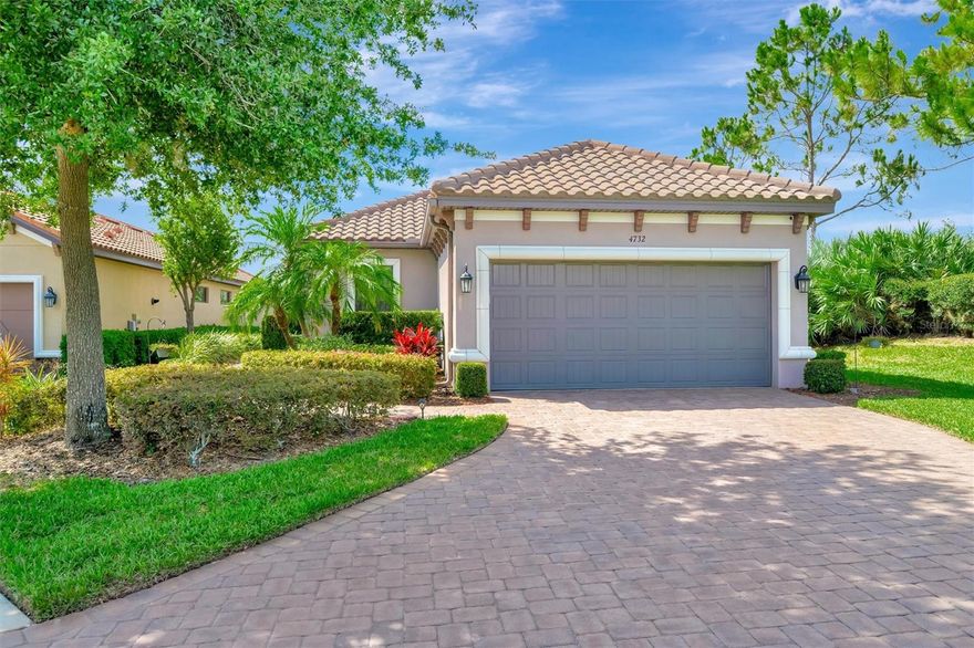 Beautifully maintained 2 bedroom, 2 bath plus den home in Esplanade at Artisan Lakes, ideally positioned as an end home on a quiet cul-de-sac with a private backyard setting. A paver driveway, tile roof, lush landscaping, and side glass panel entry create an inviting introduction before opening to a bright, comfortable floor plan with tile flooring throughout the main living areas, crown molding, tray ceilings, recessed lighting, and an easy flow between the living, dining, and kitchen spaces. The kitchen features rich wood cabinetry, granite countertops, stainless steel appliances, gas range, breakfast bar, pantry, and generous prep and storage space. The primary suite offers a walk-in closet and a beautifully finished bath with a frameless glass shower enclosure and custom wood trim around the vanity mirror. The separate den provides flexible space for a home office, reading room, or guest overflow. Additional features include a custom pleated shade on the triple slider, pull-down attic stairs, and a sealed pebble-finish garage floor. Outdoor living is enhanced by the extended screened lanai overlooking a private backyard with mature landscaping. Esplanade at Artisan Lakes offers two community centers, including a resort-style amenity center with fitness center, movement studio, event room, catering kitchen, card and craft room, billiards room and library, treatment room, covered lanai, resort-style pool, spa, resistance pool, fire pit, bocce, tennis and pickleball courts, bark parks, and playground. A second amenity center adds another pool and spa, plus billiards and ping pong for additional recreation and gathering space. From the quiet cul-de-sac location to the private backyard and impressive community amenities, this home delivers comfort, convenience, and resort-style living in one of Palmetto’s most desirable gated communities. Schedule your private tour today.