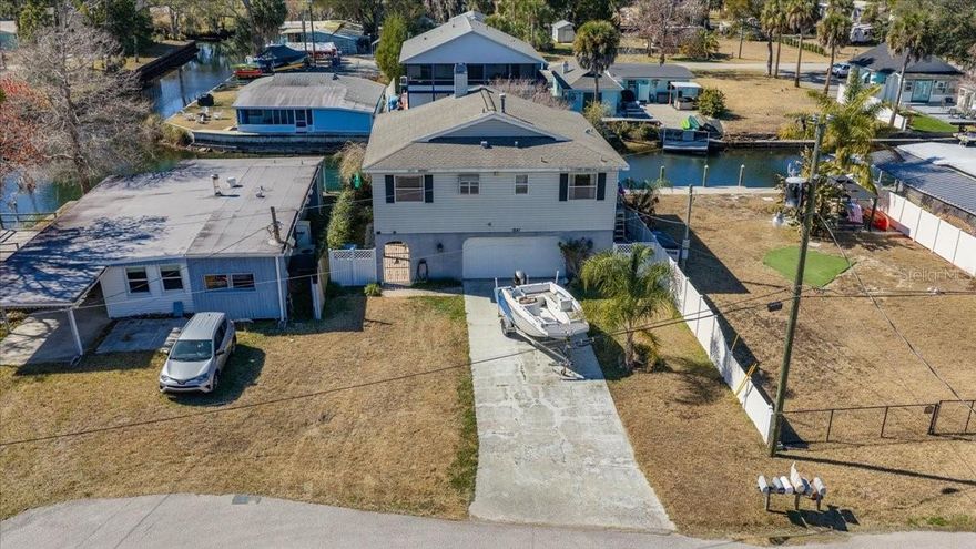 Investor Special – Diamond in the Rough on the Weeki Wachee River!
So much potential in this elevated 2 bedroom, 2 bathroom home tucked away on a quiet cul-de-sac with quick access to the main Weeki Wachee River. Just a short paddle brings you to the main river where you can enjoy crystal-clear, spring-fed waters perfect for kayaking, paddleboarding, fishing, and observing local wildlife right from your backyard.
This home offers a spacious great room floor plan with vaulted ceilings and an gas fireplace, creating an open and airy feel. Two sets of sliding glass doors lead into the Florida Room with vinyl windows, bringing in abundant natural light and additional living space to enjoy the outdoors year-round. The kitchen has a gas stove and eat in bar area and is open to the dining area and family room, ideal for entertaining.
The master suite features private sliders to the Florida Room. New carpeting in the bedrooms, vinyl flooring in the main living areas, and tile in the kitchen and baths provide a solid foundation for updates and personal touches. An inside upper-level laundry closet adds convenience.
Additional features include an oversized 2-car garage, long driveway with plenty of parking, covered back patio, and a screened back porch/Florida Room for relaxing after a day on the water. Home has TRANSFERABLE FLOOD INSURANCE of 1788 dollars annually.
Perfect for a primary residence, investment property, or vacation home. Located near Weeki Wachee Springs State Park, famous for its live mermaid shows and underwater observatory, while still close to everyday amenities.
Bring your vision and make this riverfront gem beautiful again. Don’t miss this opportunity to own a piece of waterfront paradise—schedule your showing today!