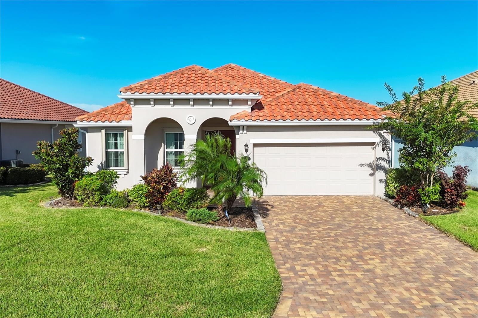 Rare Opportunity in Nalanda Estates – Dream Retirement Haven!
Step into a lifestyle filled with comfort, culture, and community with this immaculately maintained 3 bedroom, 2.5 bathroom home, showcasing the sought-after Munnar I Floor Plan. Perfectly located in the highly desirable Nalanda Estates in Parrish, Florida, this home is not just a place to live—it’s the beginning of a vibrant new chapter.
From the moment you arrive, you’ll notice the thoughtful upgrades and pride of ownership that make this residence stand out. As you step inside, the spacious open layout welcomes you with upgraded tile flooring throughout the main living areas, abundant natural light. The chef-inspired kitchen is a dream, featuring solid wood cabinets, stainless steel appliances, Quartz countertops, an upgraded backsplash, and a custom hood venting outside—perfect for creating meals while entertaining family and friends. This home is thoughtfully designed with numerous upgrades that bring both function and style. The kitchen, bedrooms, mudroom, and garage are all equipped with upgraded cabinetry, providing an abundance of storage and a refined, custom look throughout. The master suite is a true retreat, featuring a beautifully extended walk-in closet for added space and organization, along with a dedicated study area that has been thoughtfully upgraded to create a quiet, productive corner within your private oasis.
One of the secondary bedroom comes with a built-in Murphy bed, making it a versatile space that can effortlessly transition between a guest bedroom and a home office. For added comfort outdoors, the owner has installed a remote-controlled awning, allowing you to enjoy shade and relaxation at the touch of a button. The extended lanai overlooking a peaceful lake view offers the perfect setting to enjoy your morning coffee/tea or evening coffee/tea, soak in the serenity, or host gatherings in the beautiful Florida weather.
This home was built with • Hurricane accordion shutters for peace of mind • Gutters installed for added functionality. If gardening is your passion, you’ll love the opportunity to create your very own backyard retreat, whether that’s fresh vegetables, fruit trees, or a flourishing herb garden—already made simple by the home’s layout and yard space.
Beyond the home itself, Nalanda Estates offers a lifestyle like no other. This is not just a community—it’s a Dream Retirement Haven where neighbors become lifelong friends. Enjoy a huge ballroom for cultural celebrations and social events, a theater room showing Bollywood movies, a resort-style pool, pickleball courts, fitness center, and dedicated areas for cards, bingo, and group activities. With a full calendar of events and daily opportunities to connect, there is always something to do, something to celebrate, and someone to share it with.